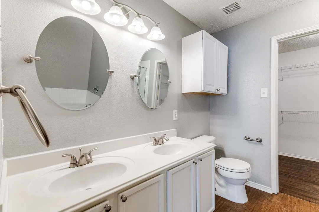 Bathroom featuring dark wood-style floors, a textured ceiling, and a spacious closet
