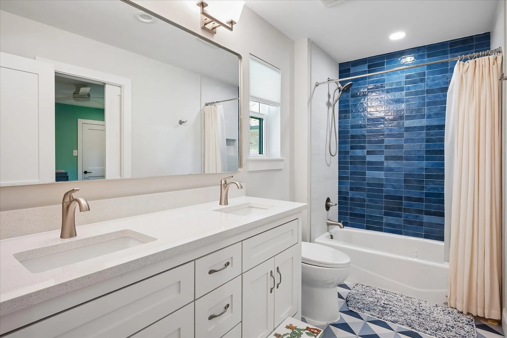 Dual vanity with light-toned countertops and undermount sinks