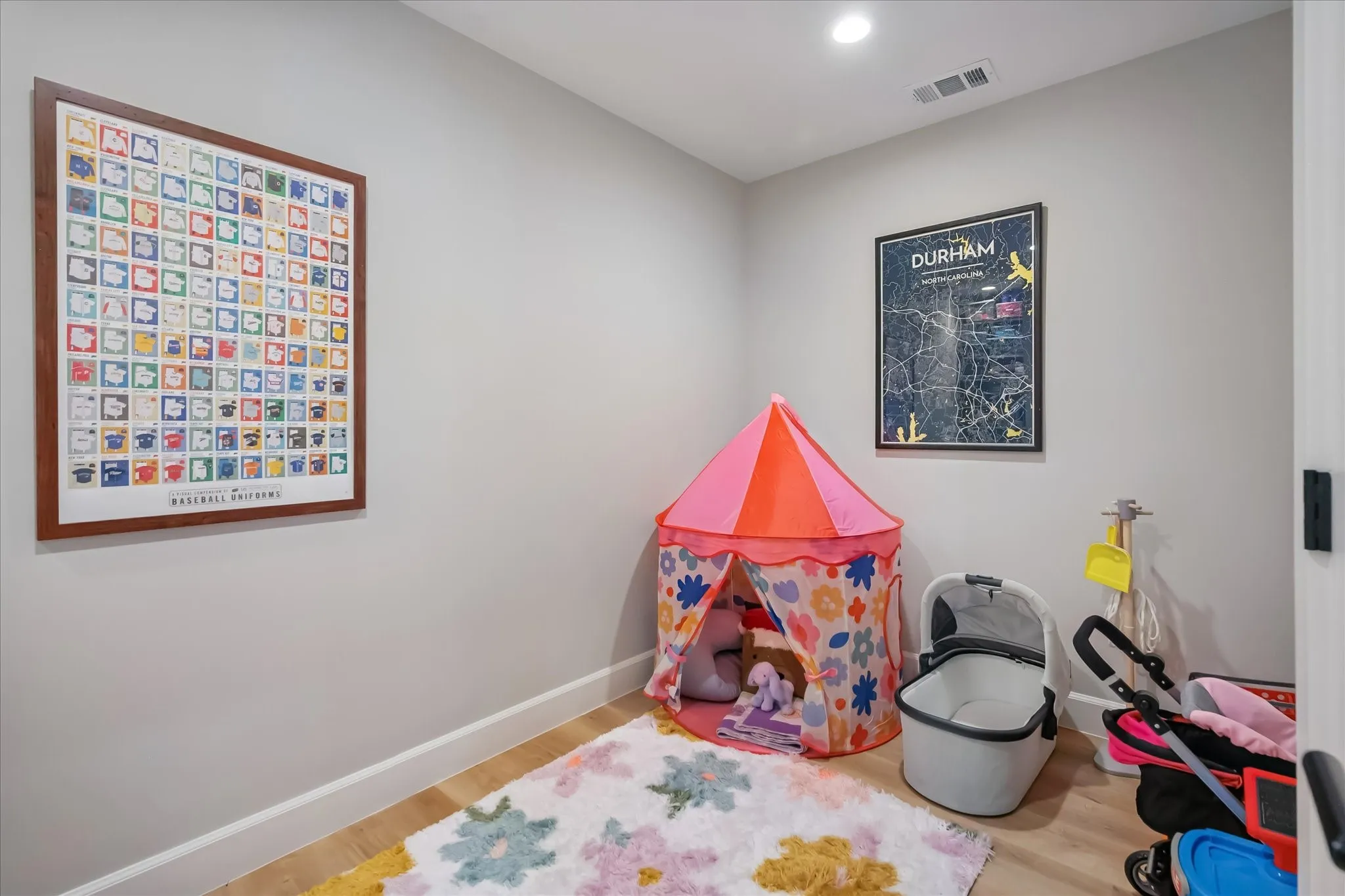 Recessed lighting, wood-finish flooring, and light-toned walls