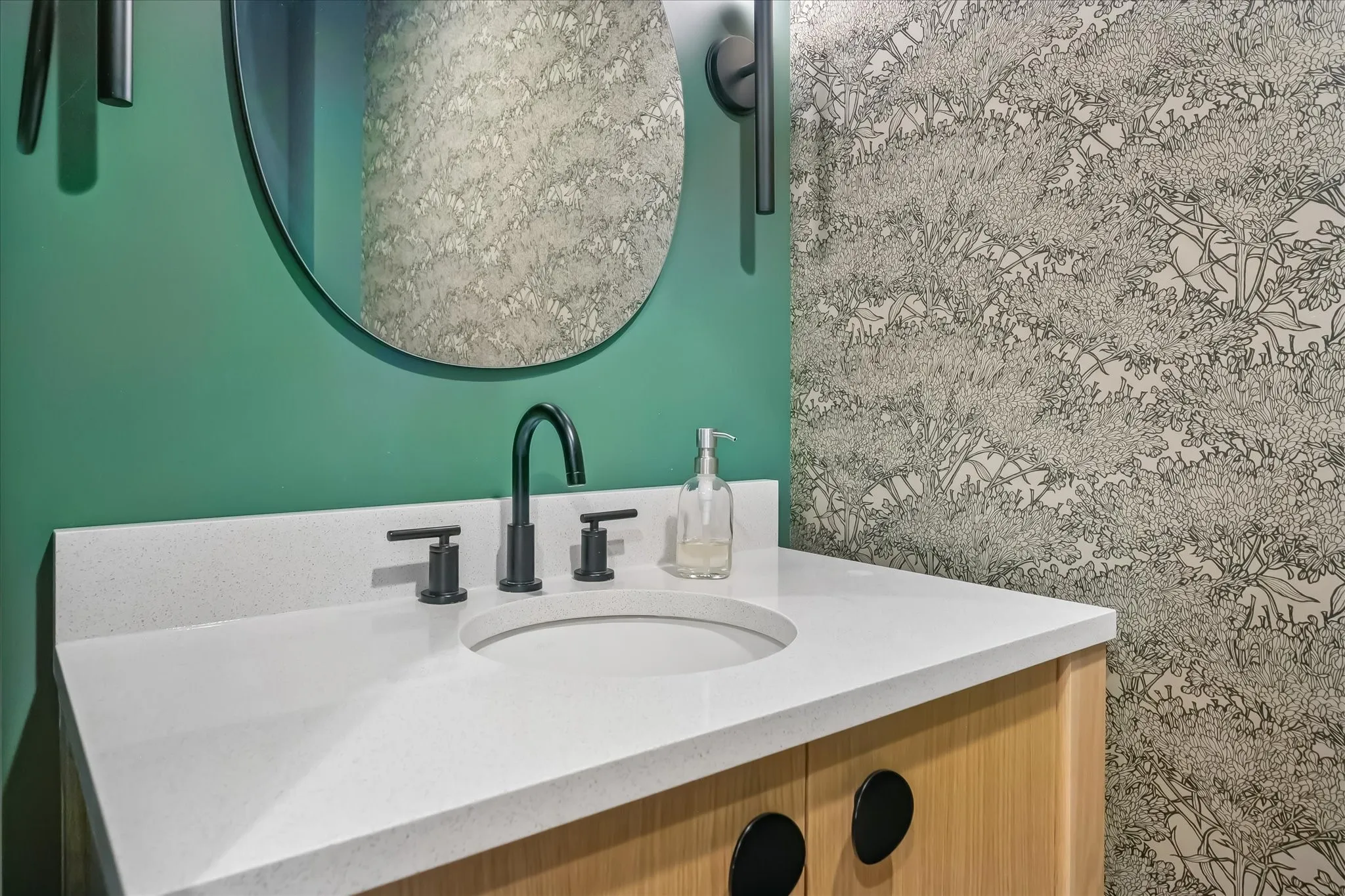 Vanity with a white countertop, built-in sink, and matte black faucet