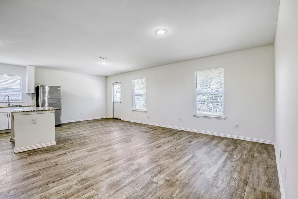 rear door to back yard area , dining room adjoins kitchen