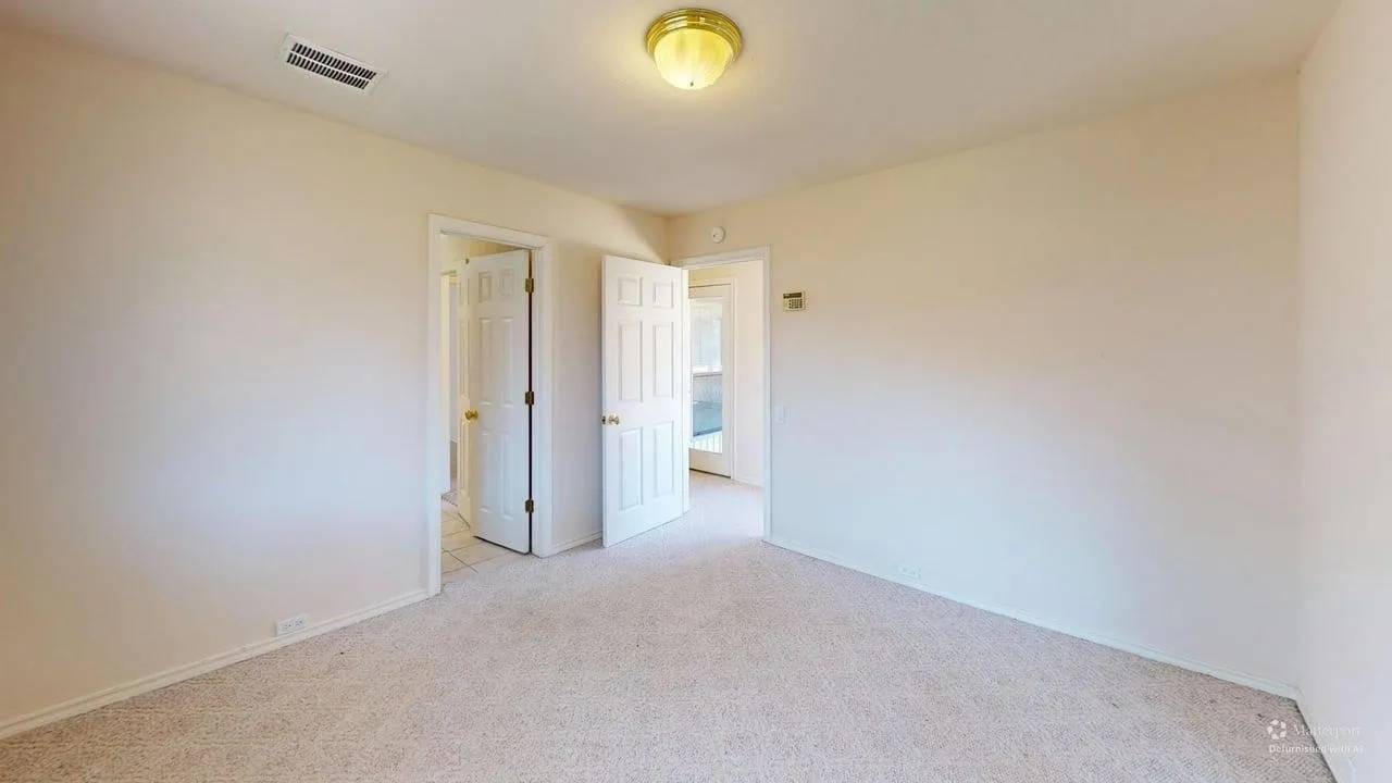 Neutral-toned walls complement plush carpeting
