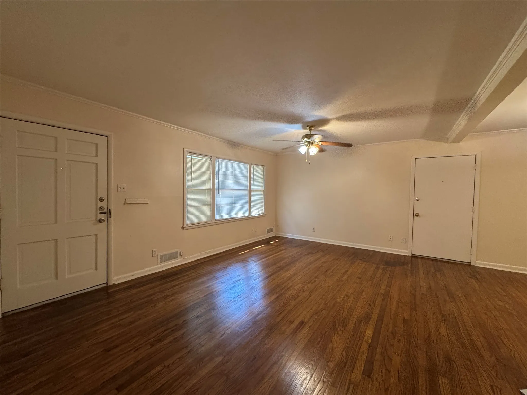Another view of living room with ceiling fan, blinds and wood finish flooring