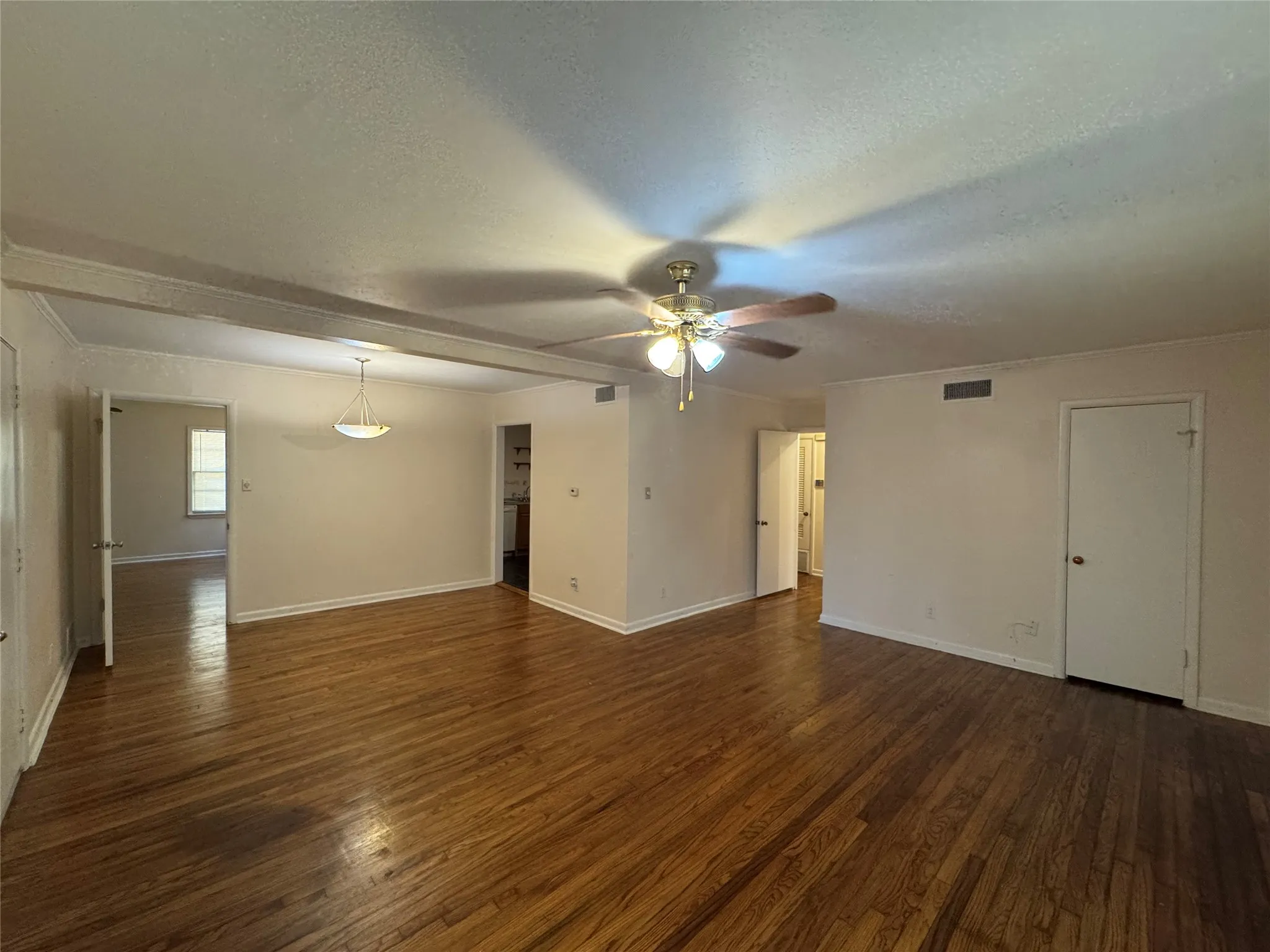 Open flow of living and dining rooms with wood finish flooring