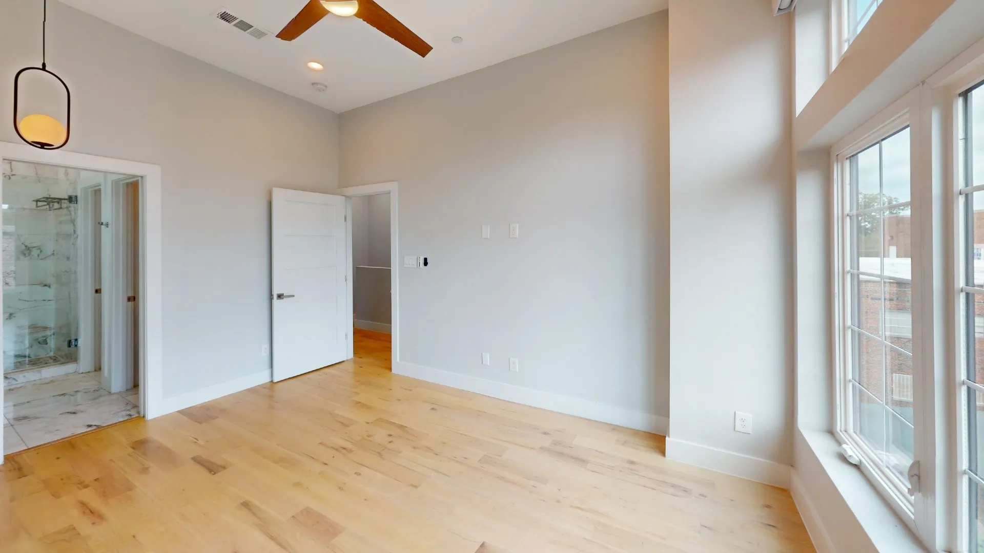 Hardwood flooring, high ceilings, large windows, ceiling fan, and recessed lighting
