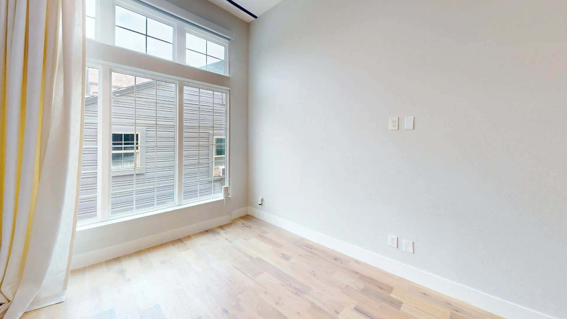 Wood-finish flooring, high ceilings, expansive window array, and recessed lighting