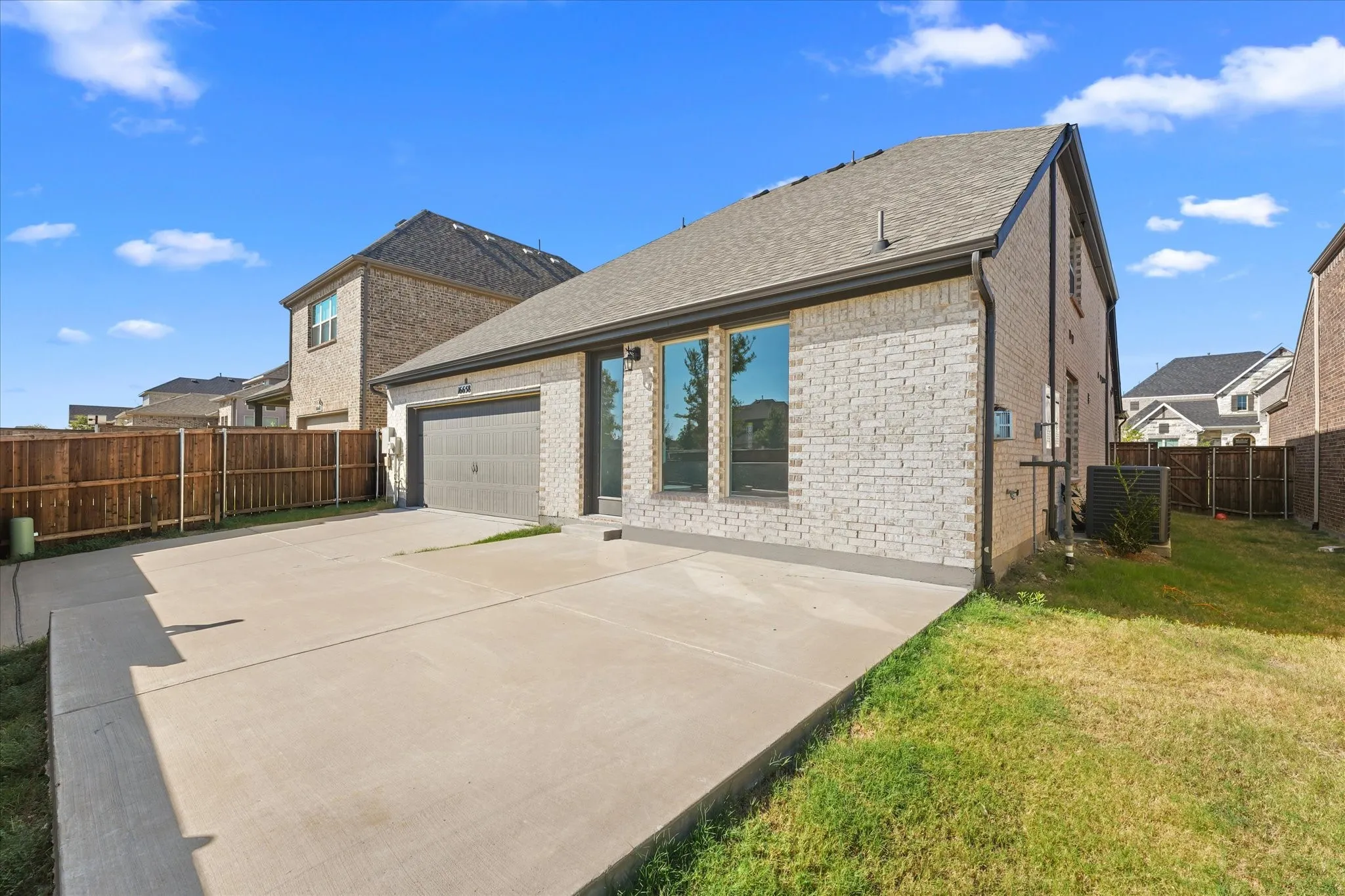 Brick exterior with a single-car garage and concrete driveway