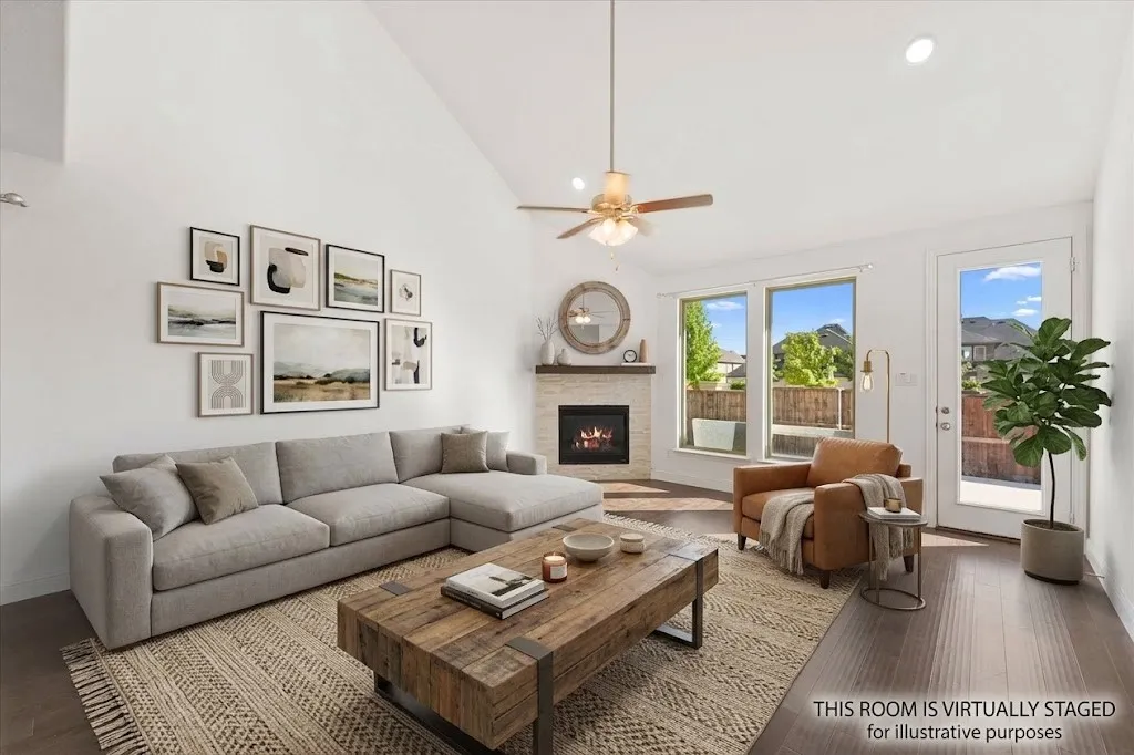 Vaulted ceiling, recessed lighting, wood-finish flooring, stone-surround fireplace, and ceiling fan - Virtually Staged