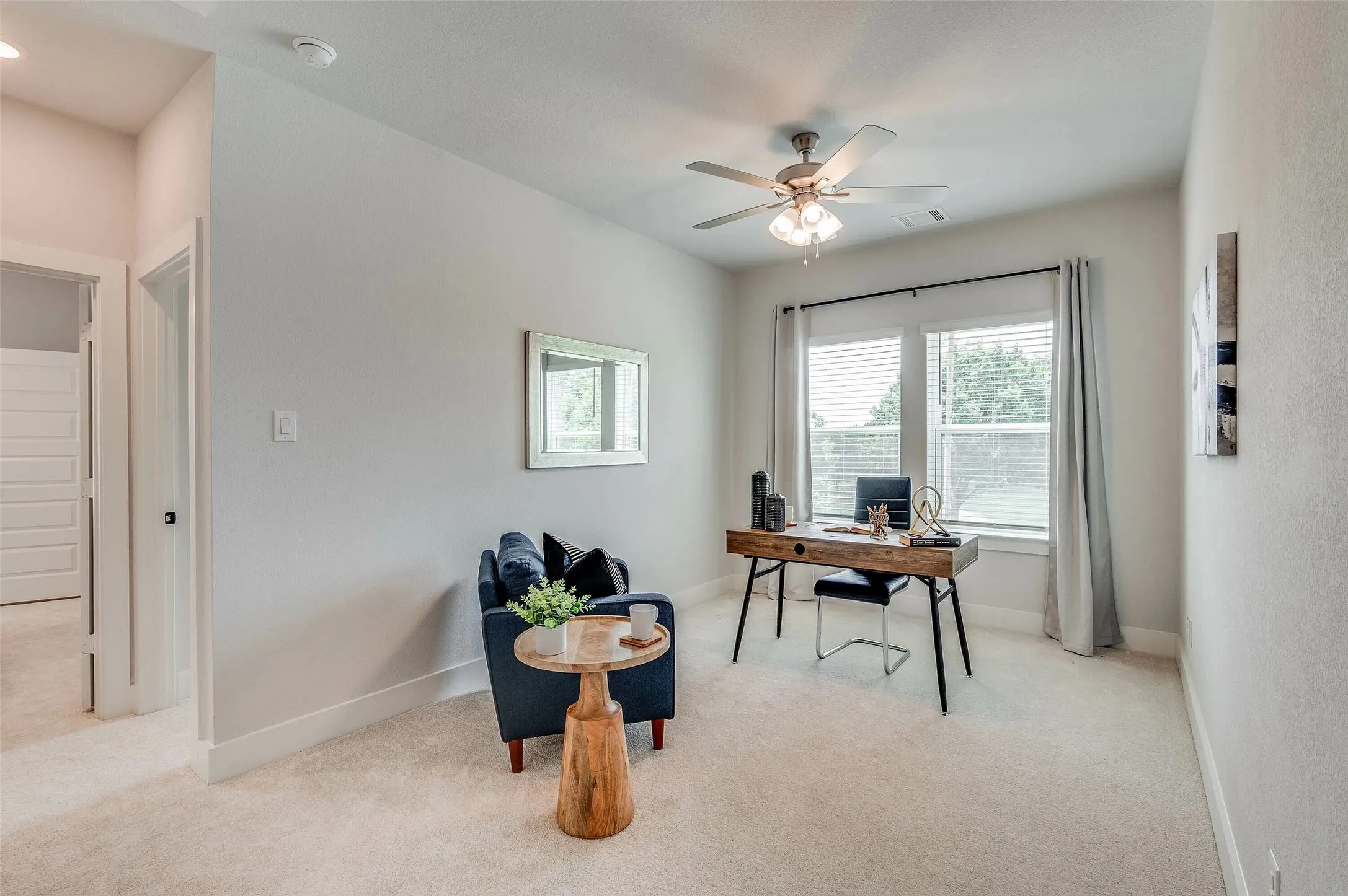 Recessed lighting, ceiling fan with integrated light, dual windows with blinds, and light-toned wall paint