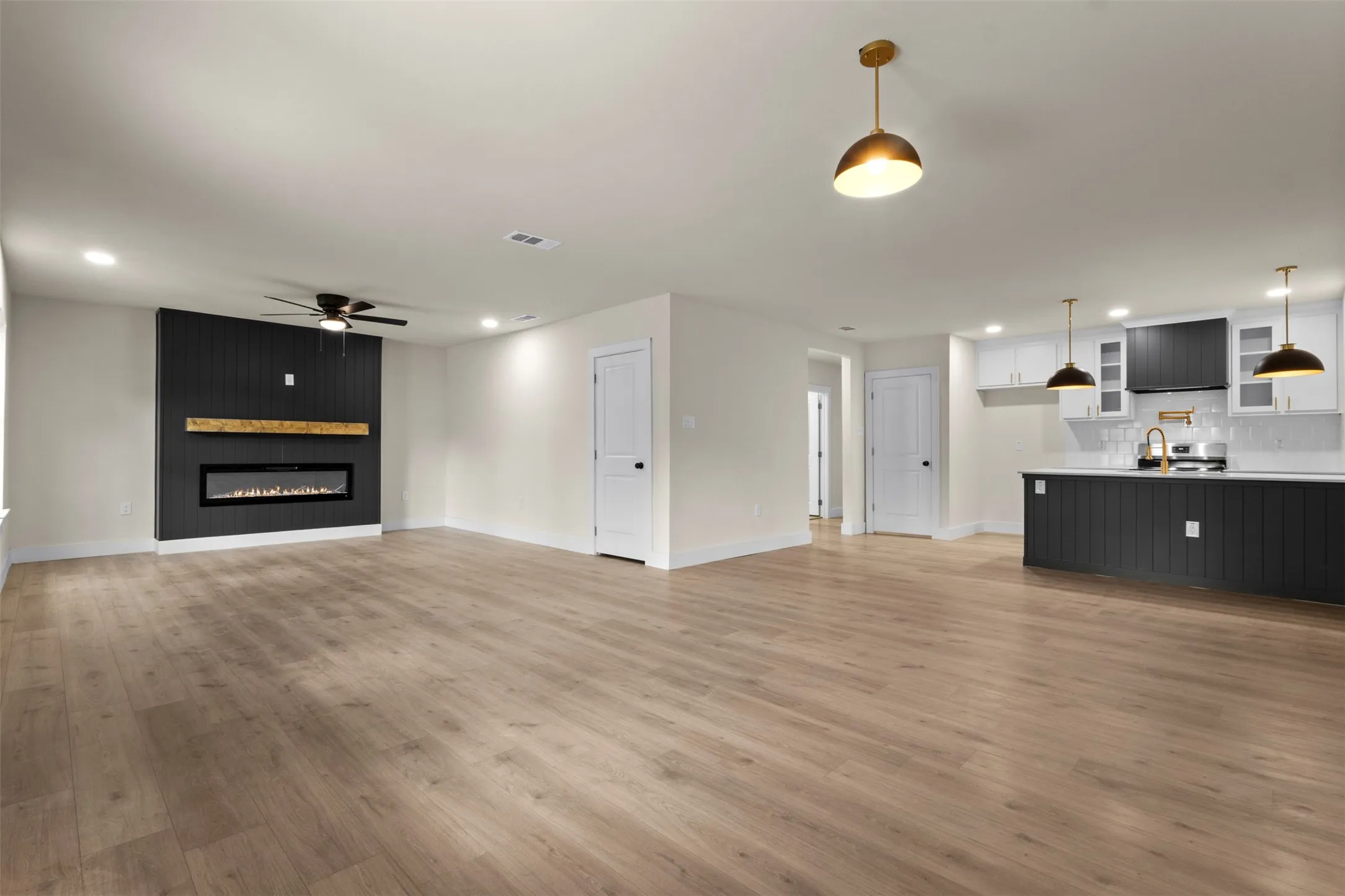 Open concept living area featuring wood-finish flooring