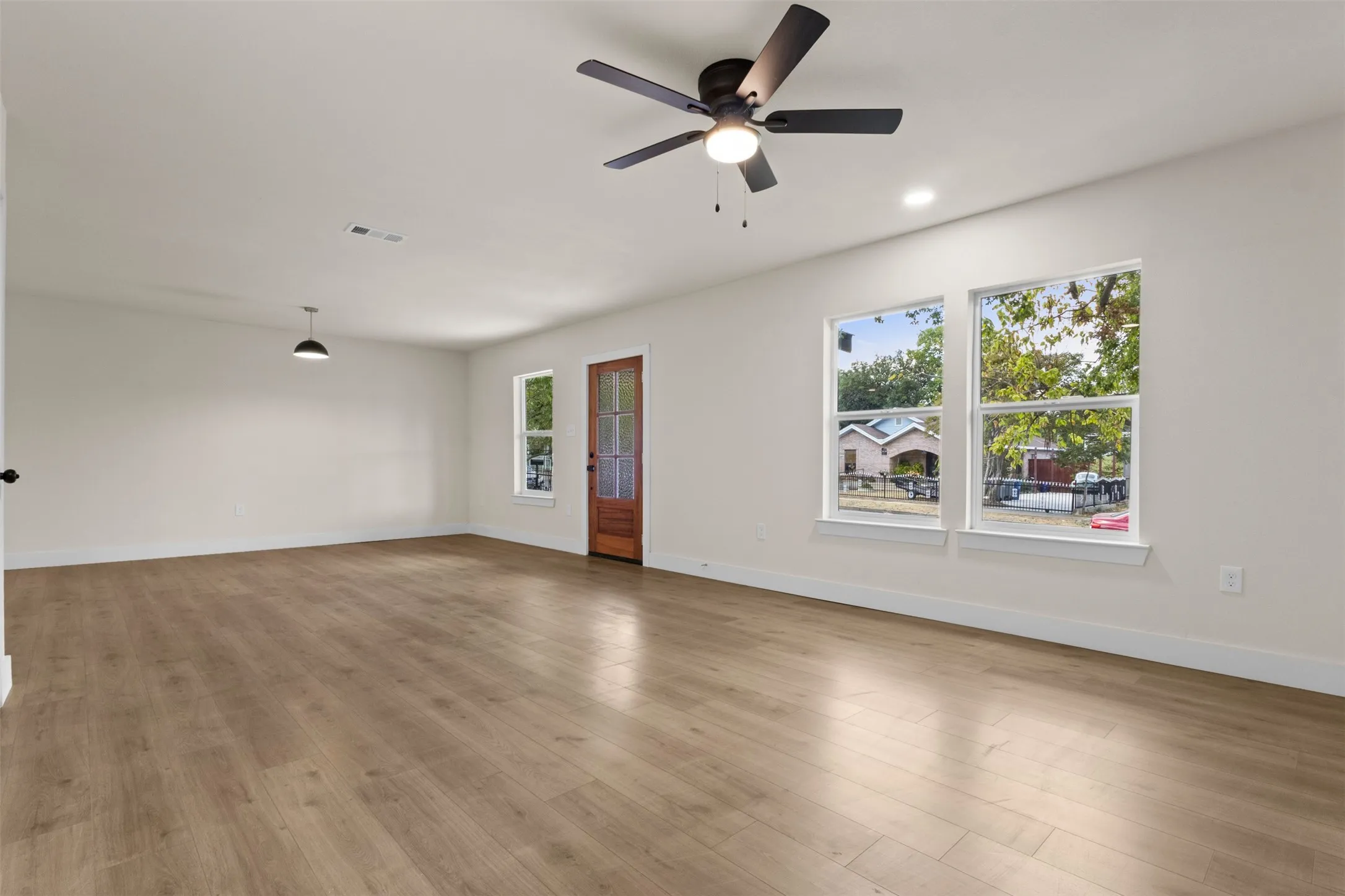 Wood-finish flooring, recessed lighting, and a modern ceiling fan