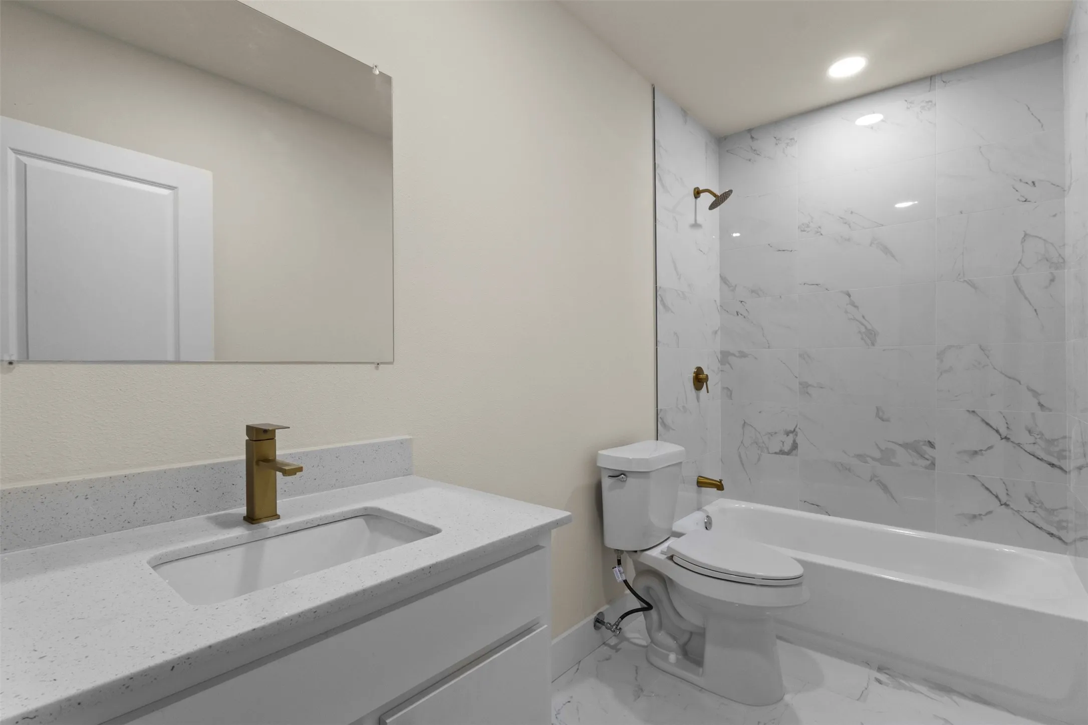 Modern vanity with an integrated rectangular sink and gold-finish faucet