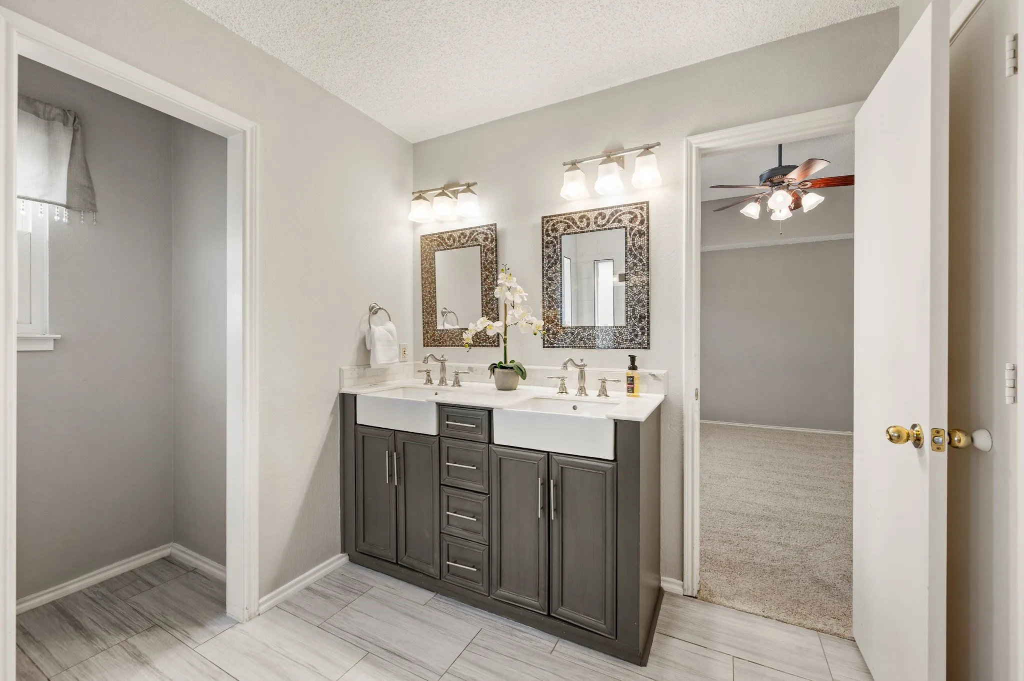 Dual vanities, stylish cabinetry & decorative mirrors add function & charm to the primary bath.