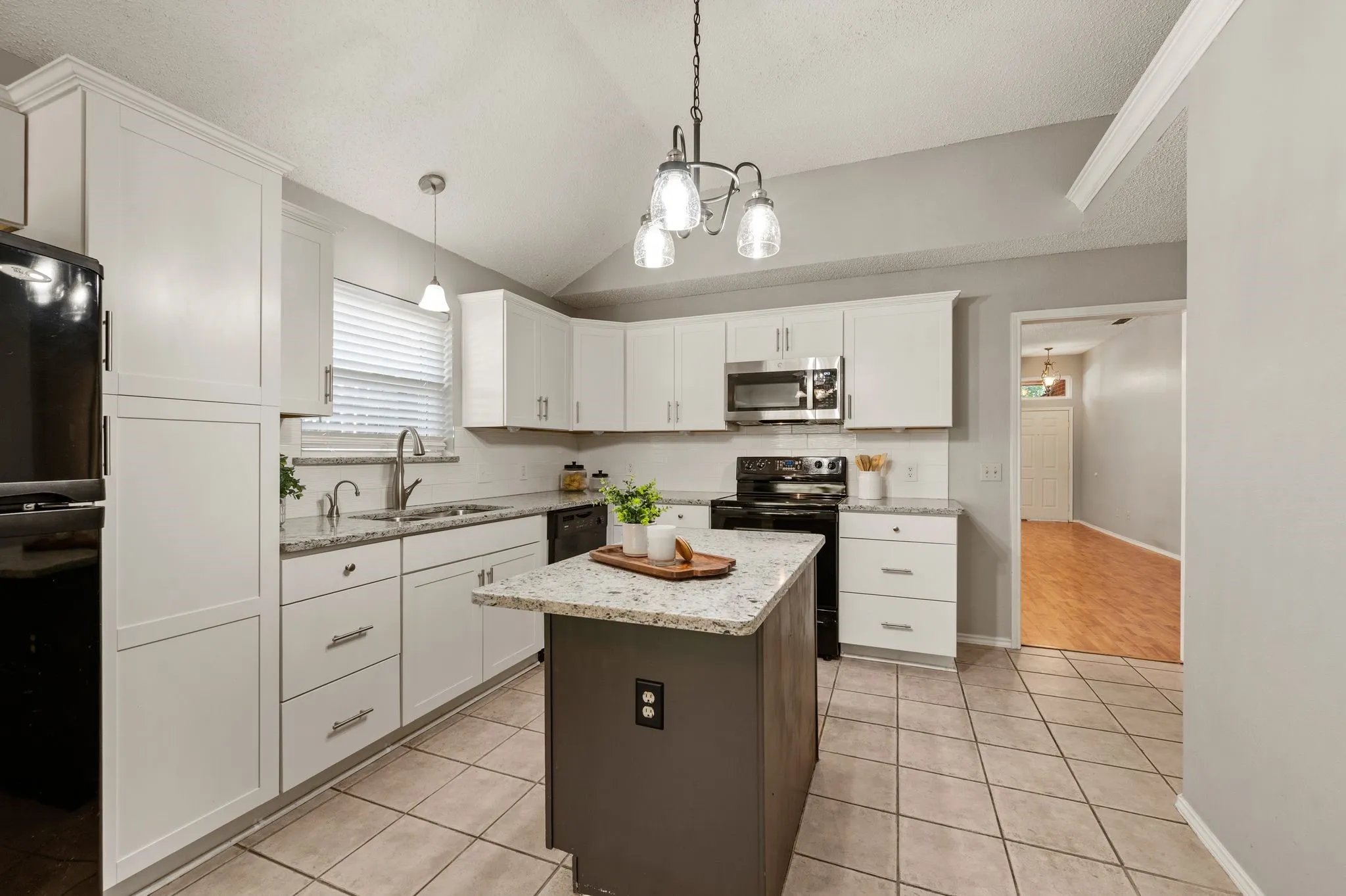 Bright kitchen offers generous cabinetry, an island & two pantry's.