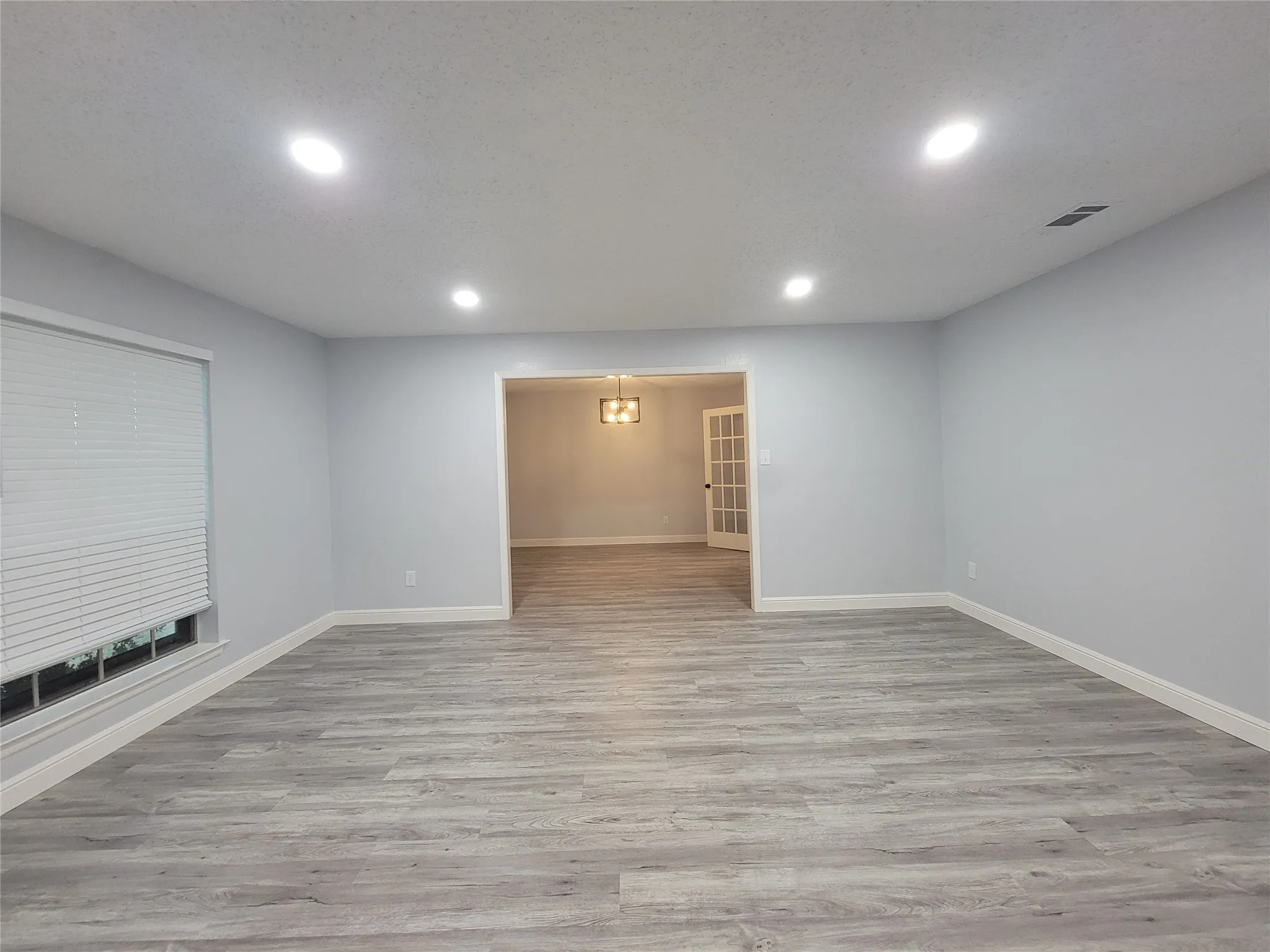 Recessed lighting and wood-finish flooring