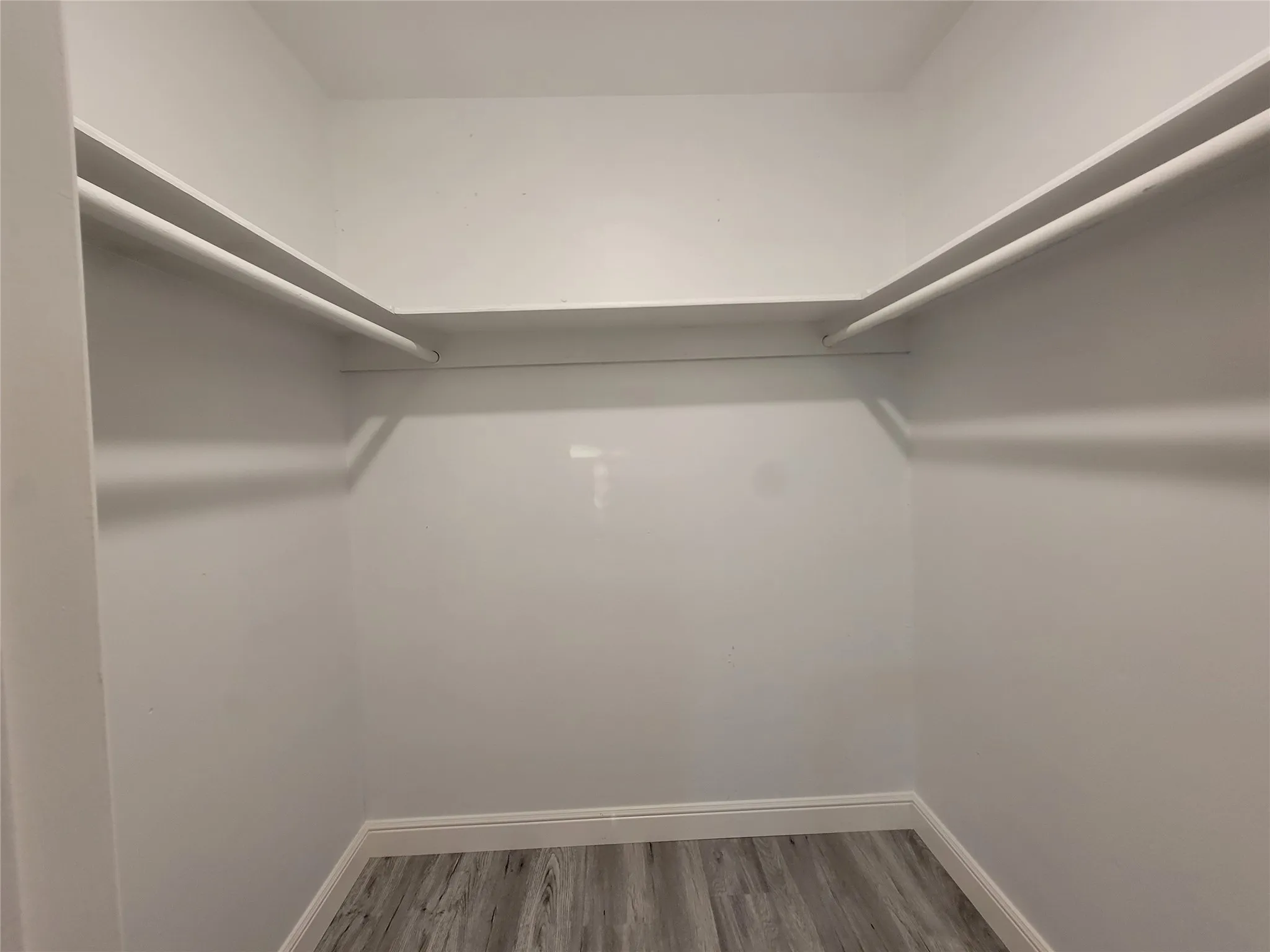 Wall-to-wall shelving with hanging rods