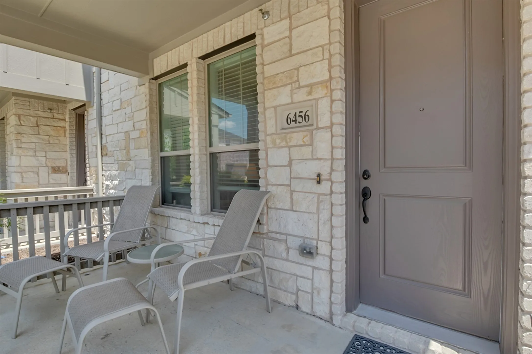 Stone veneer exterior with a covered porch