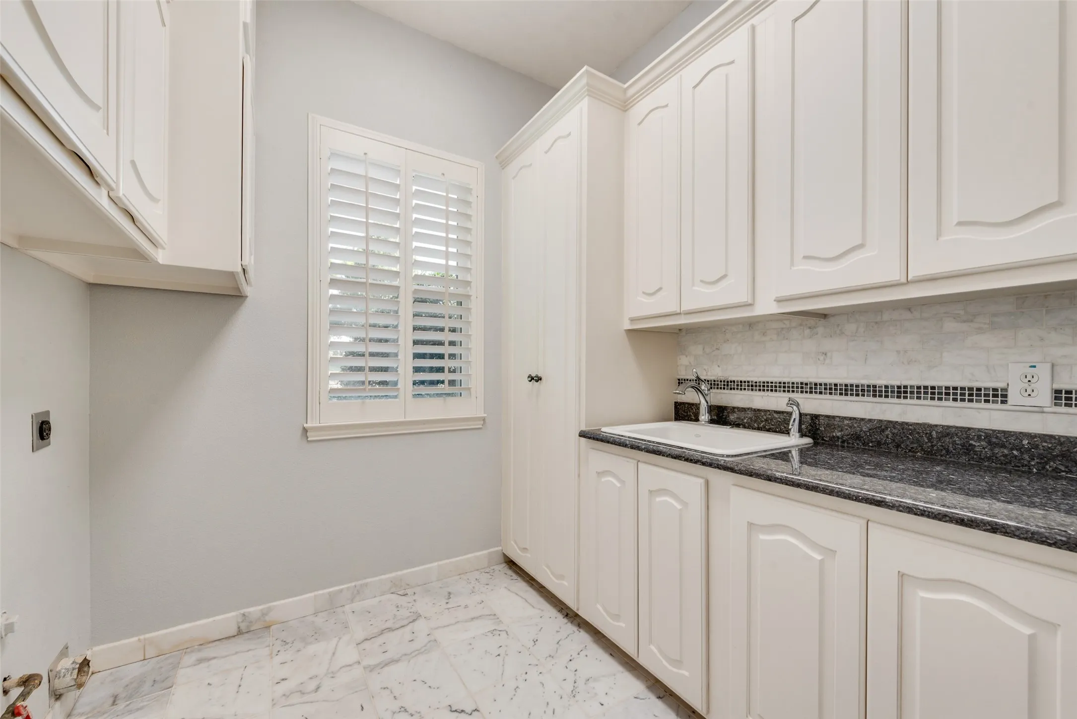 MARBLE FLOORING, DEEP UTILITY SINK, STORAGE, AND LAUNDRY CHUTE