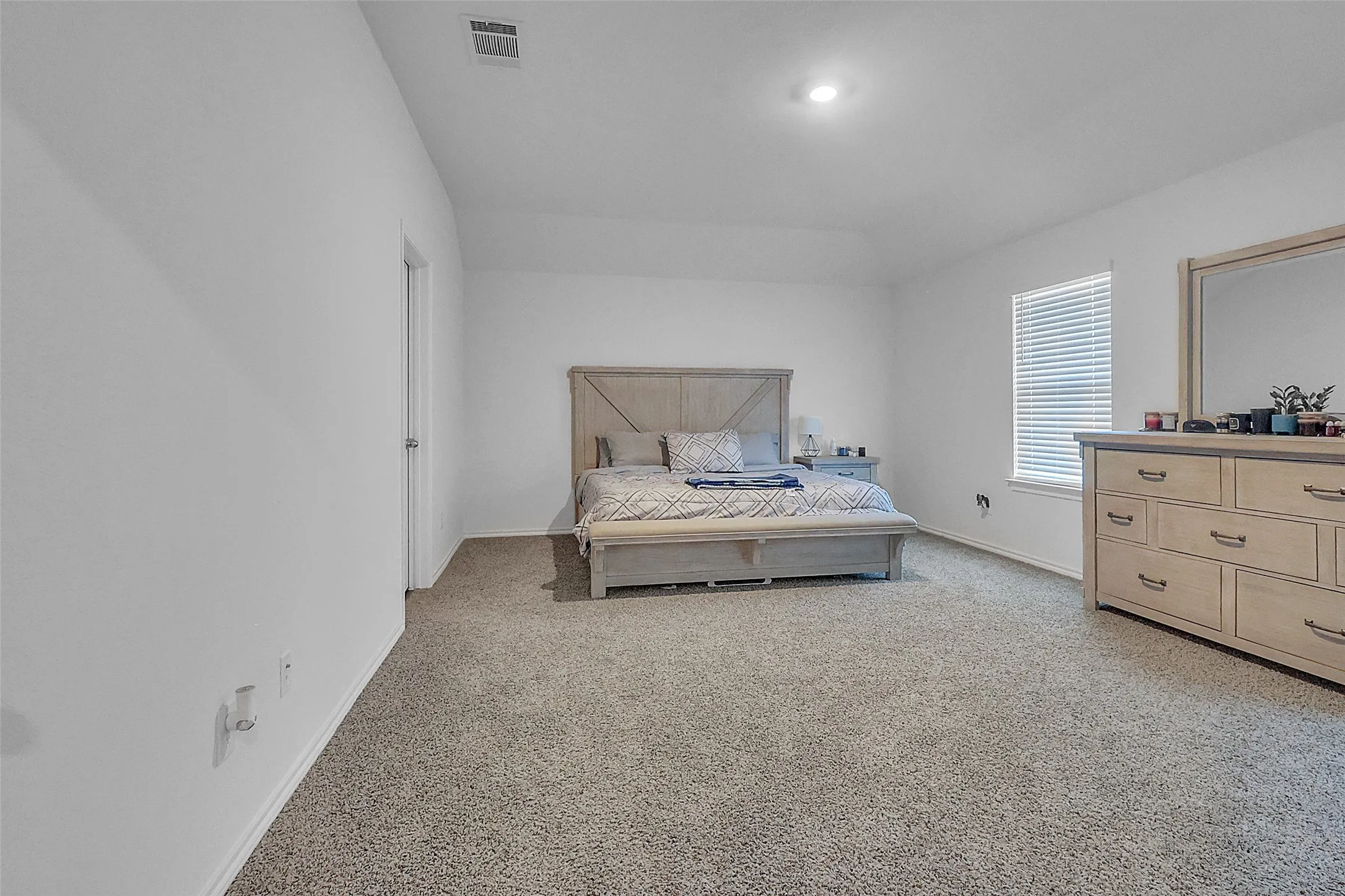Carpeted flooring, recessed lighting, window with blinds, white walls, and a white door