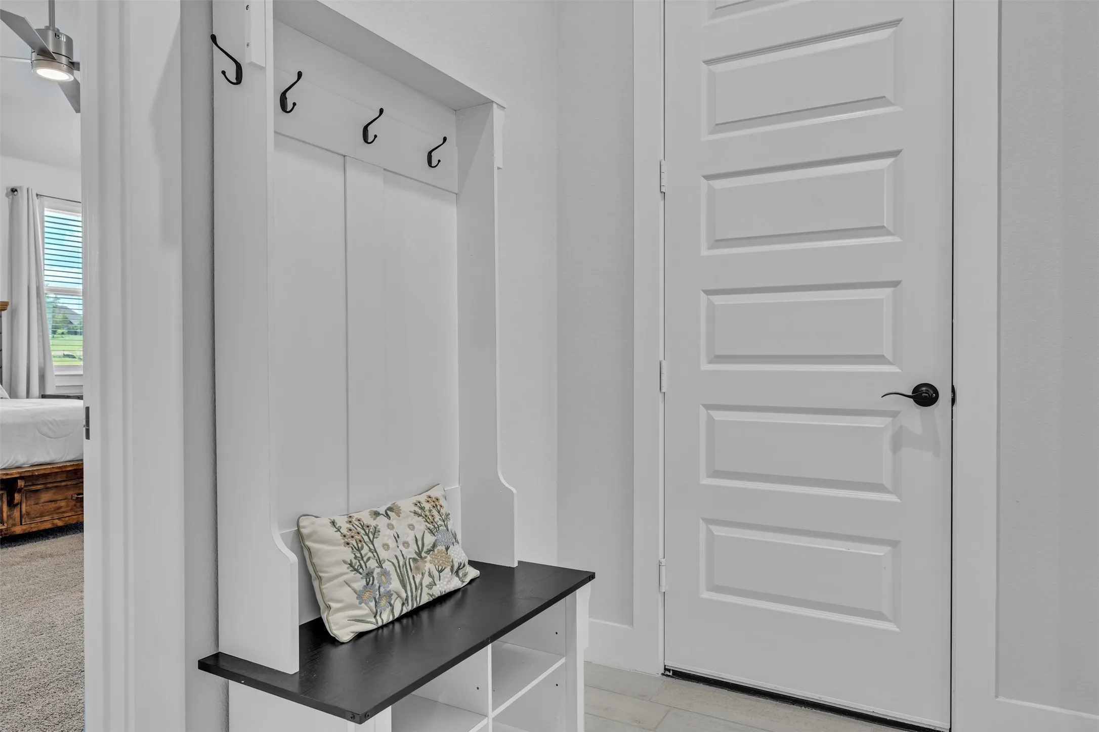Built-in mudroom bench with storage cubbies and coat hooks