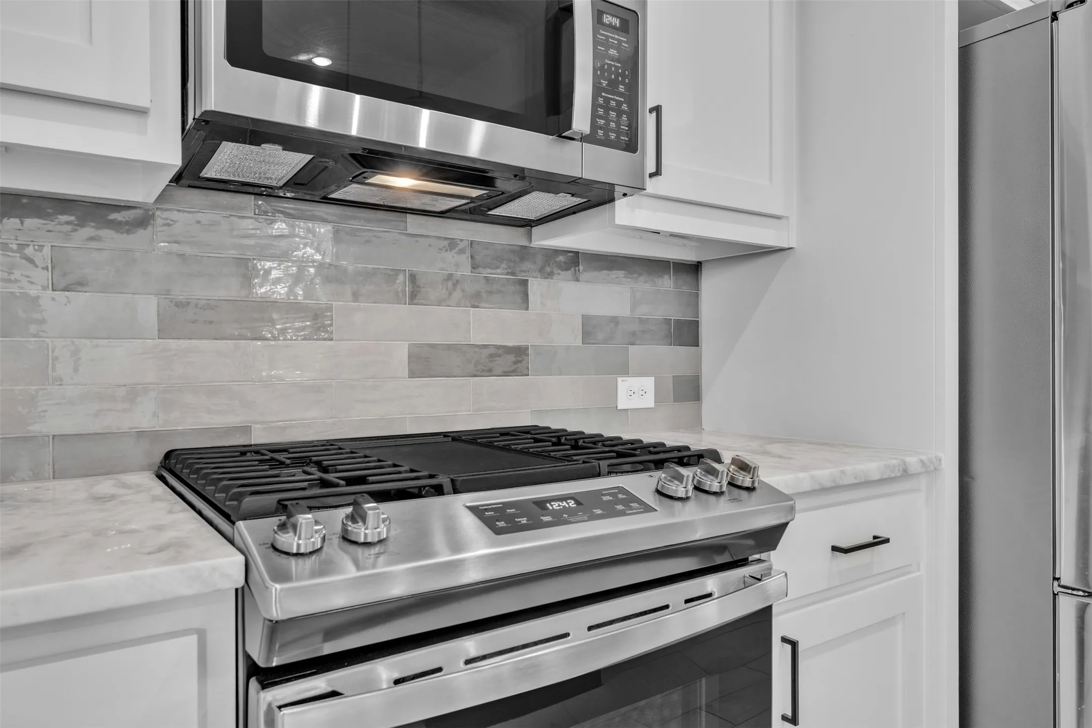 Stainless steel range with a coordinating microwave oven