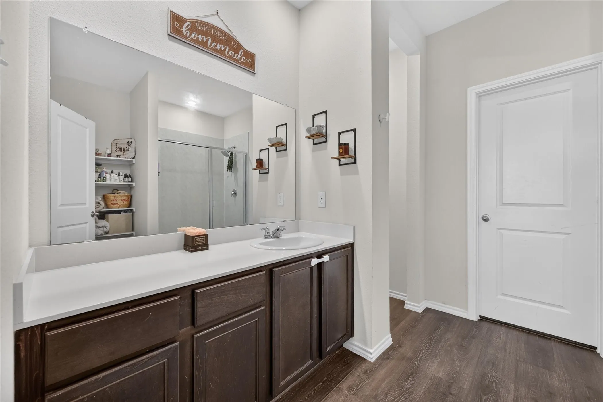 Spacious vanity with a white countertop and dark wood-finish cabinetry