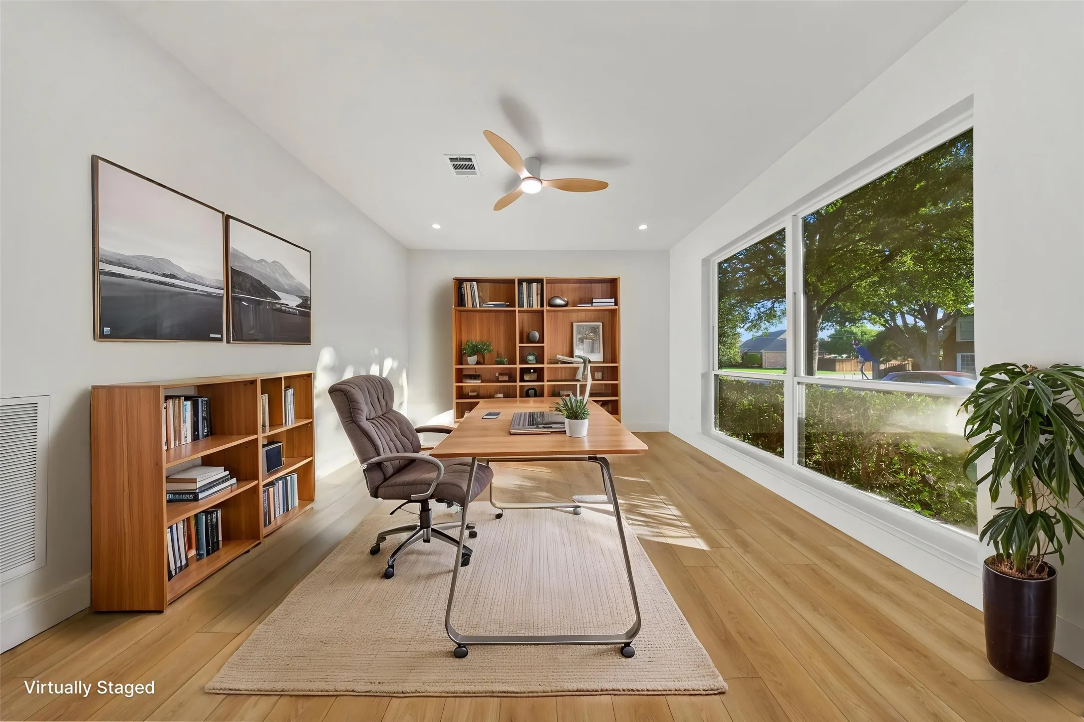 Office space featuring wood-finish flooring, a contemporary ceiling fan, recessed lighting, and a broad window with white trim