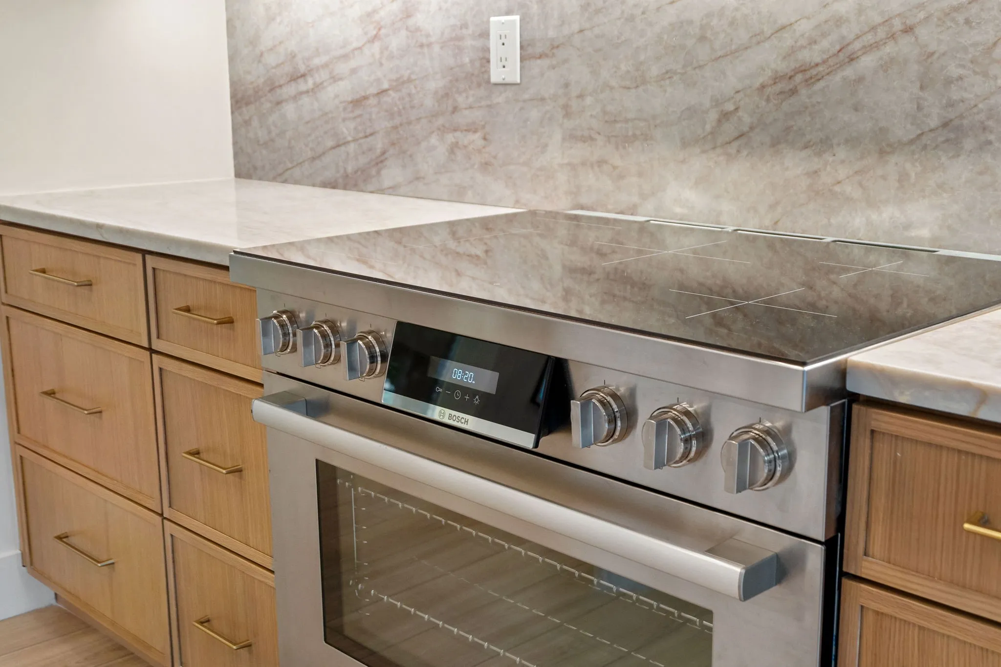 Stainless steel range with a glass cooktop and integrated oven