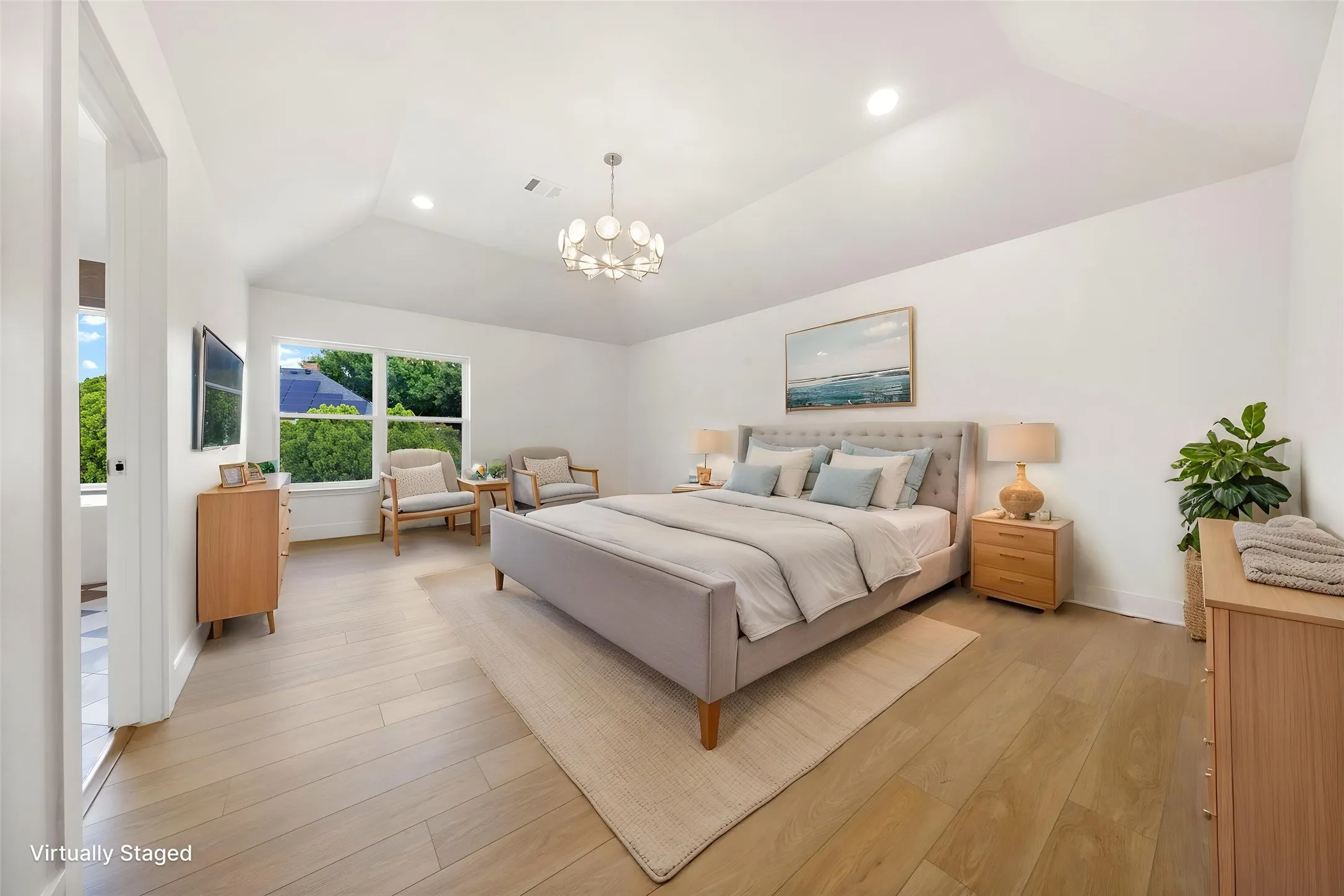 Vaulted ceiling with recessed lighting and a contemporary chandelier