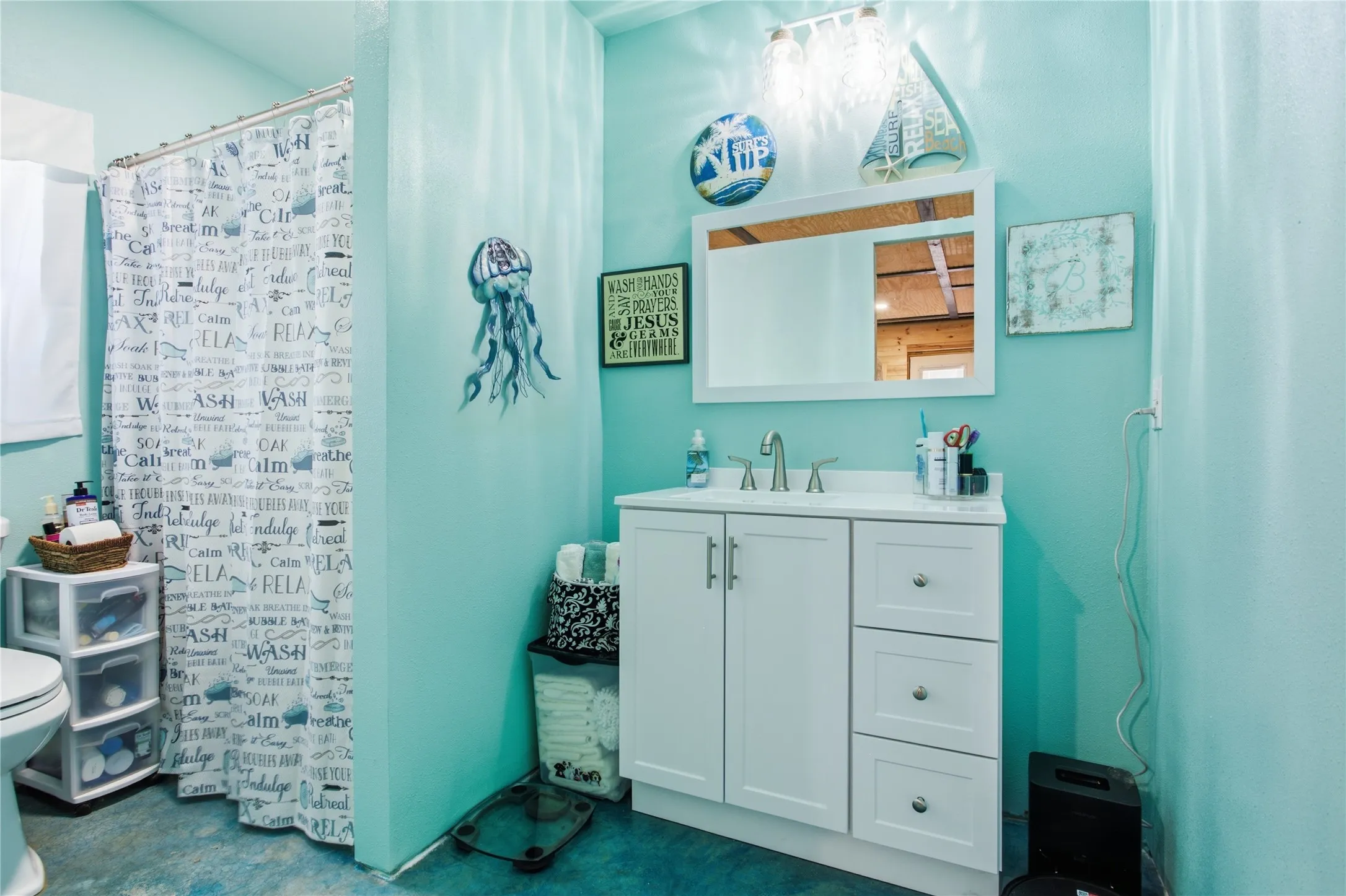 Vanity with white cabinetry and chrome hardware, white countertop, and wall-mounted mirror