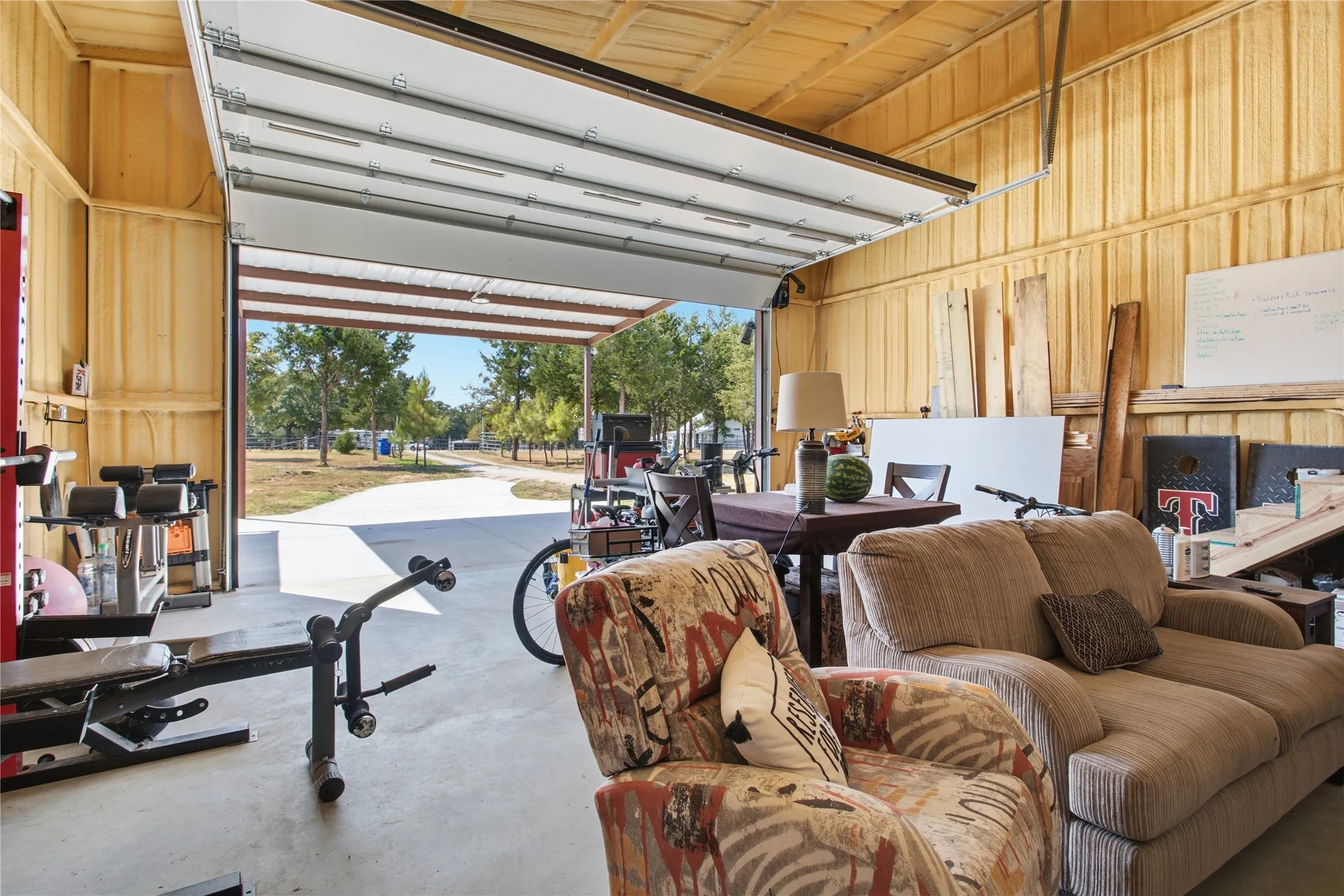 Large overhead garage door leading to an outdoor area