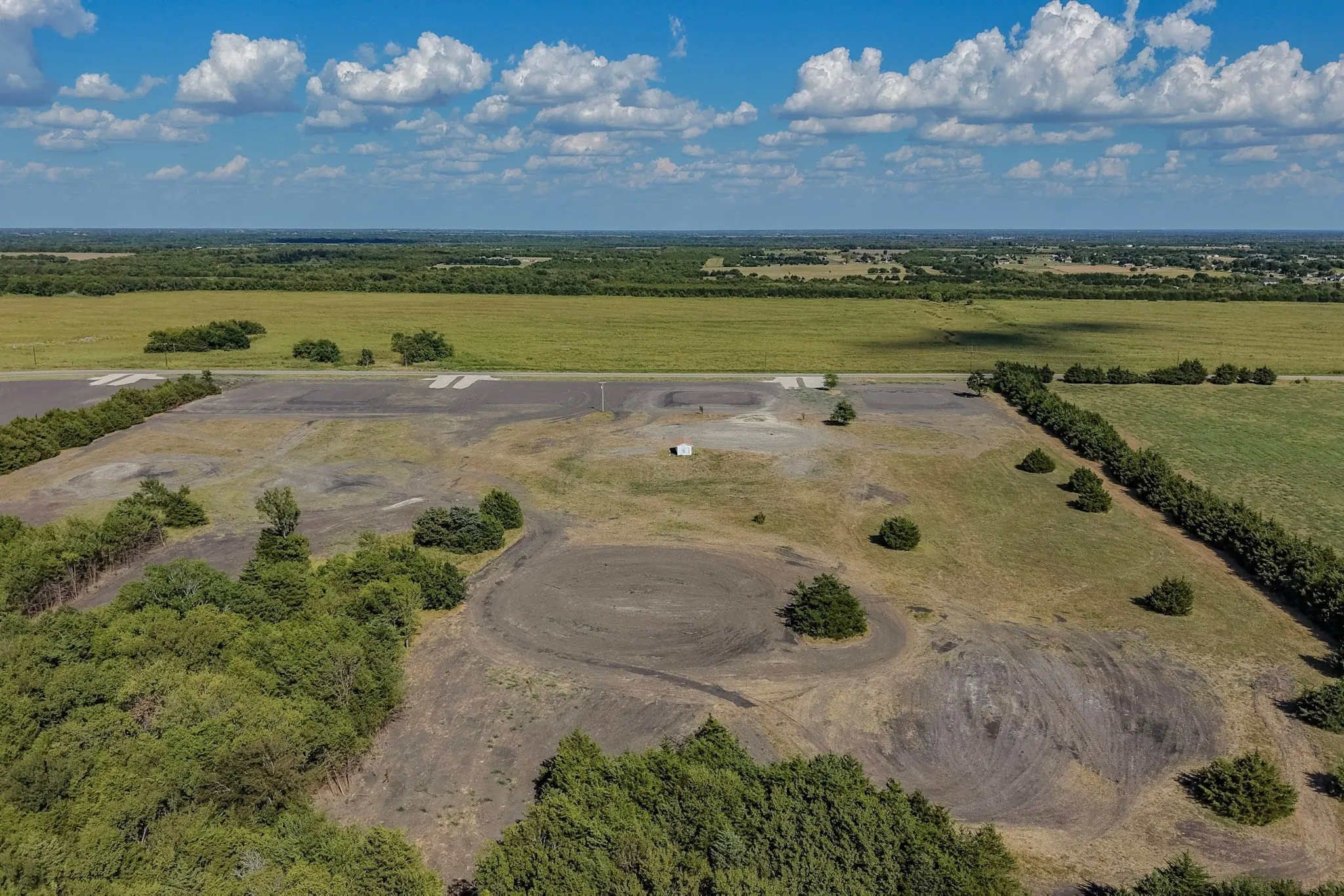 Expansive acreage featuring a mix of open fields and treed sections