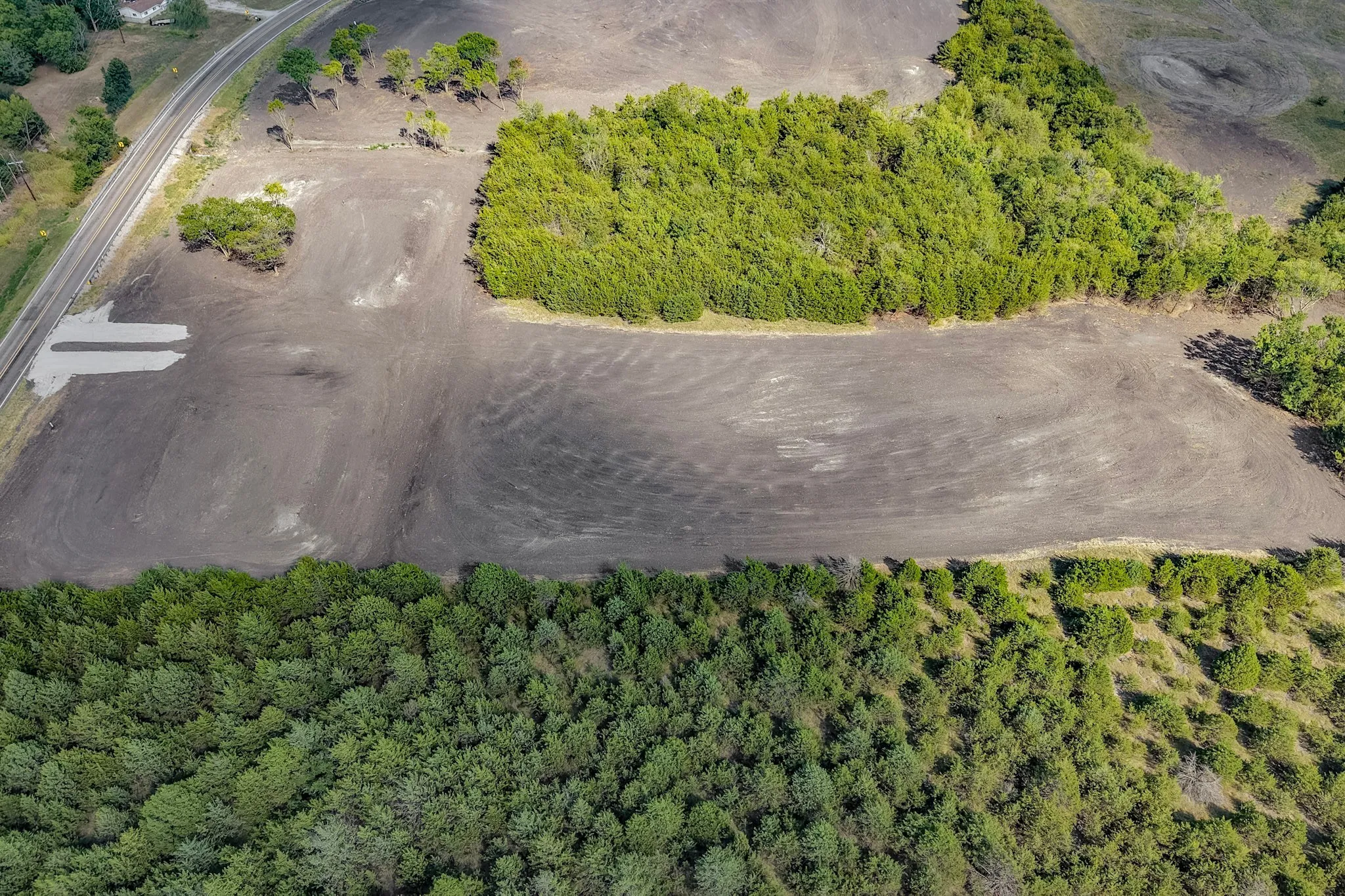 Expansive land parcel featuring cleared areas and established tree lines