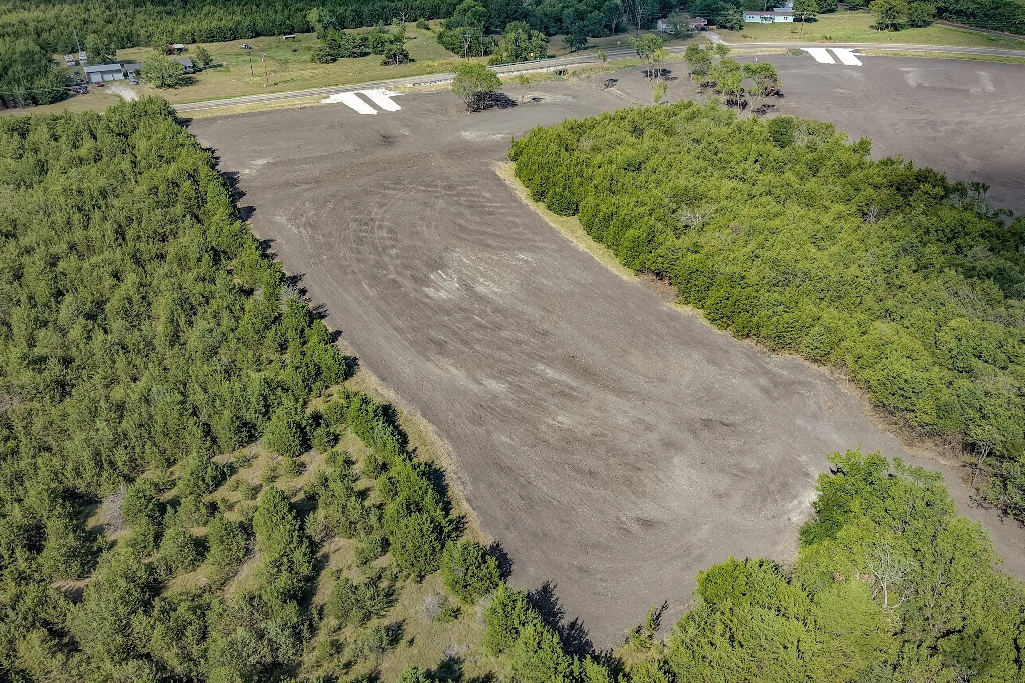 Expansive cleared land featuring surrounding mature trees