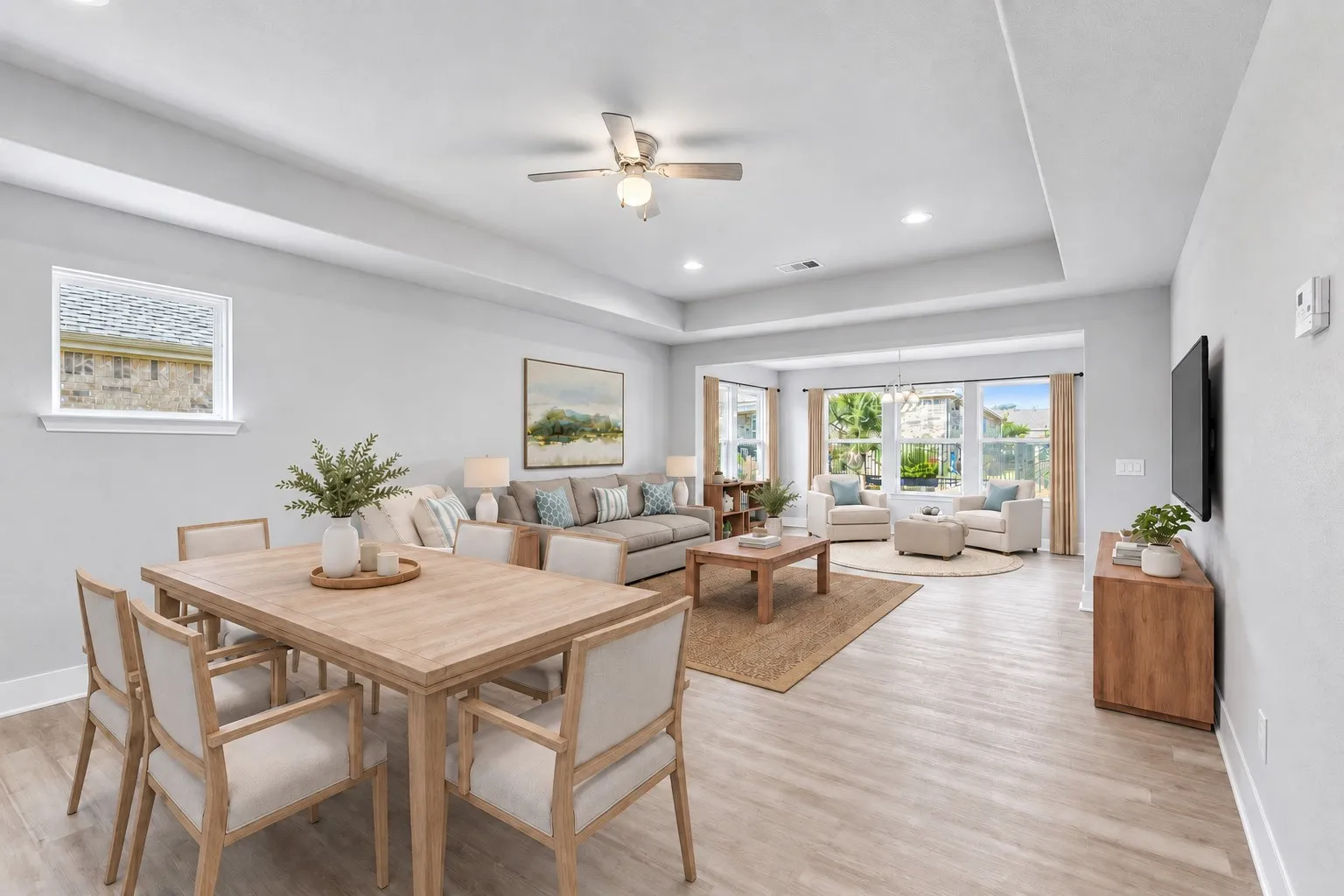 The open-concept dining and living layout offers exceptional flexibility for a variety of furniture arrangements and entertaining styles. Virtually staged to show potential design options.