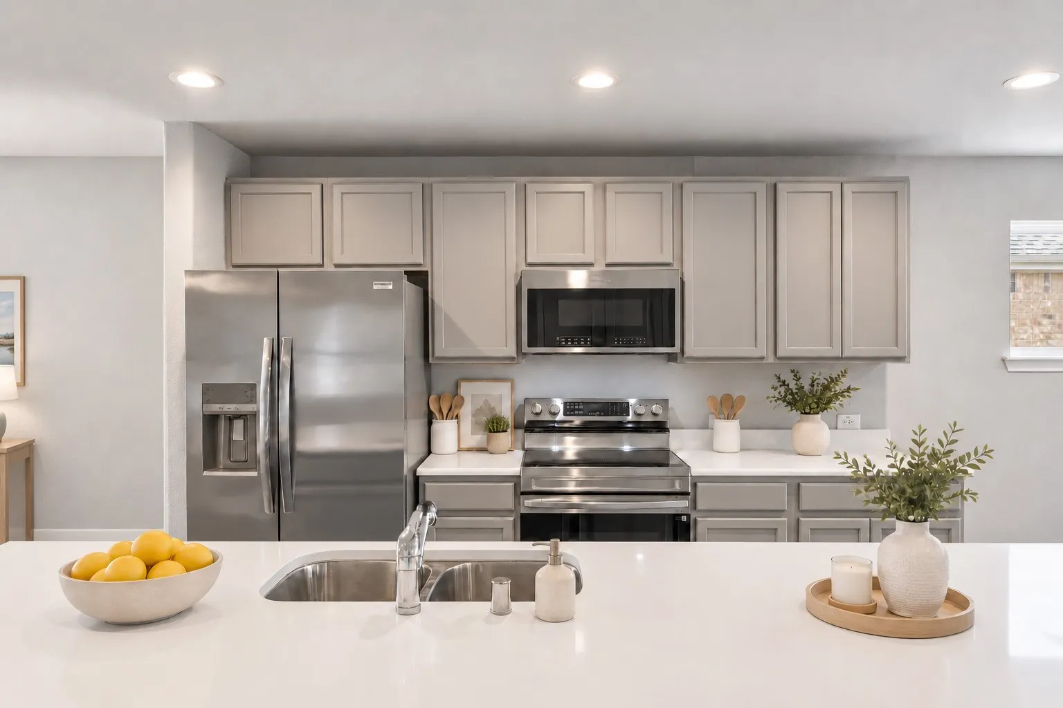 Oversized kitchen island provides additional space for dining. Sleek quartz countertops really elevate the design of this space. Virtually staged to show potential design options.