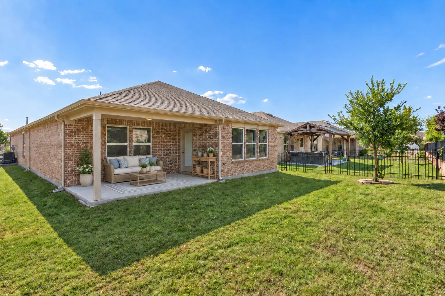 The covered patio and backyard provides wonderful potential for gardening, relaxing outdoors, or creating a peaceful green space. Virtually staged to show potential furniture placement.