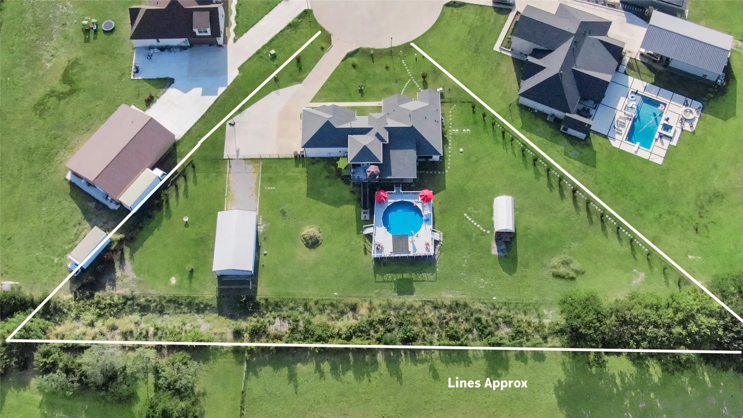 Expansive property featuring a meticulously maintained lawn, an above-ground pool, and a storage shed