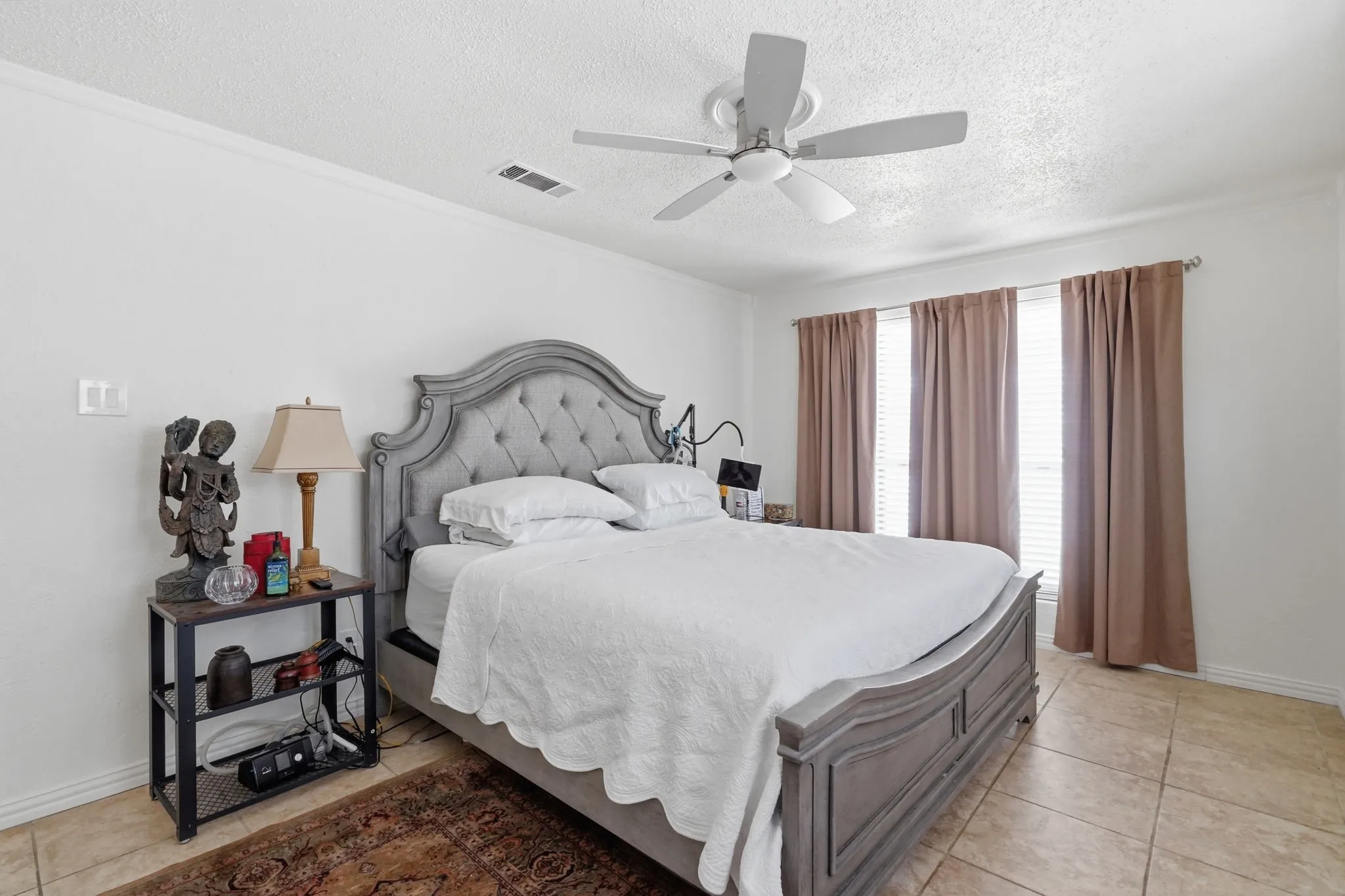 Recessed windows with blinds, ceiling fan with integrated lighting, and tile flooring