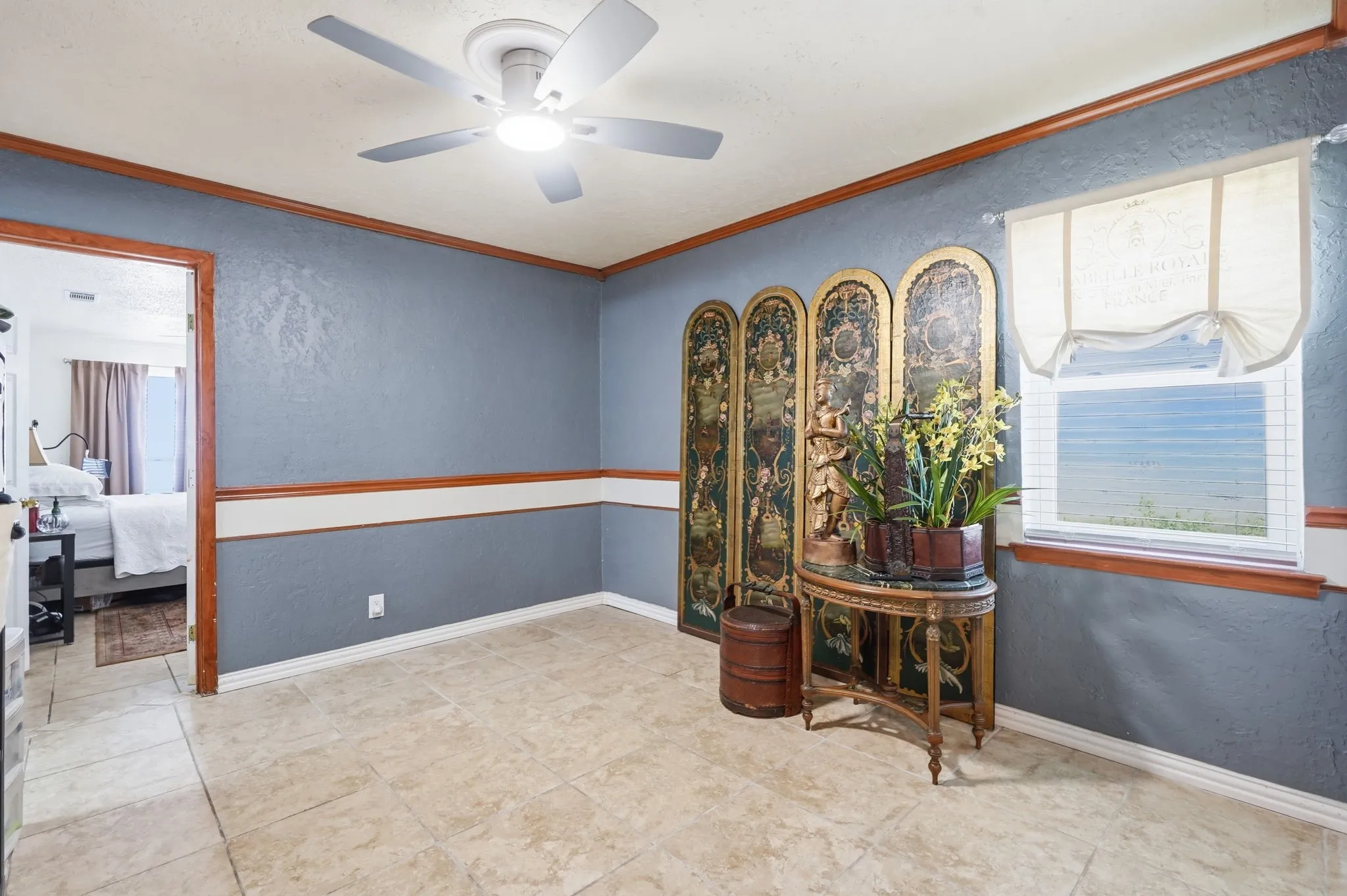 Recessed lighting, ceiling fan with integrated light, wood trim accents, natural light from a window, and tile flooring