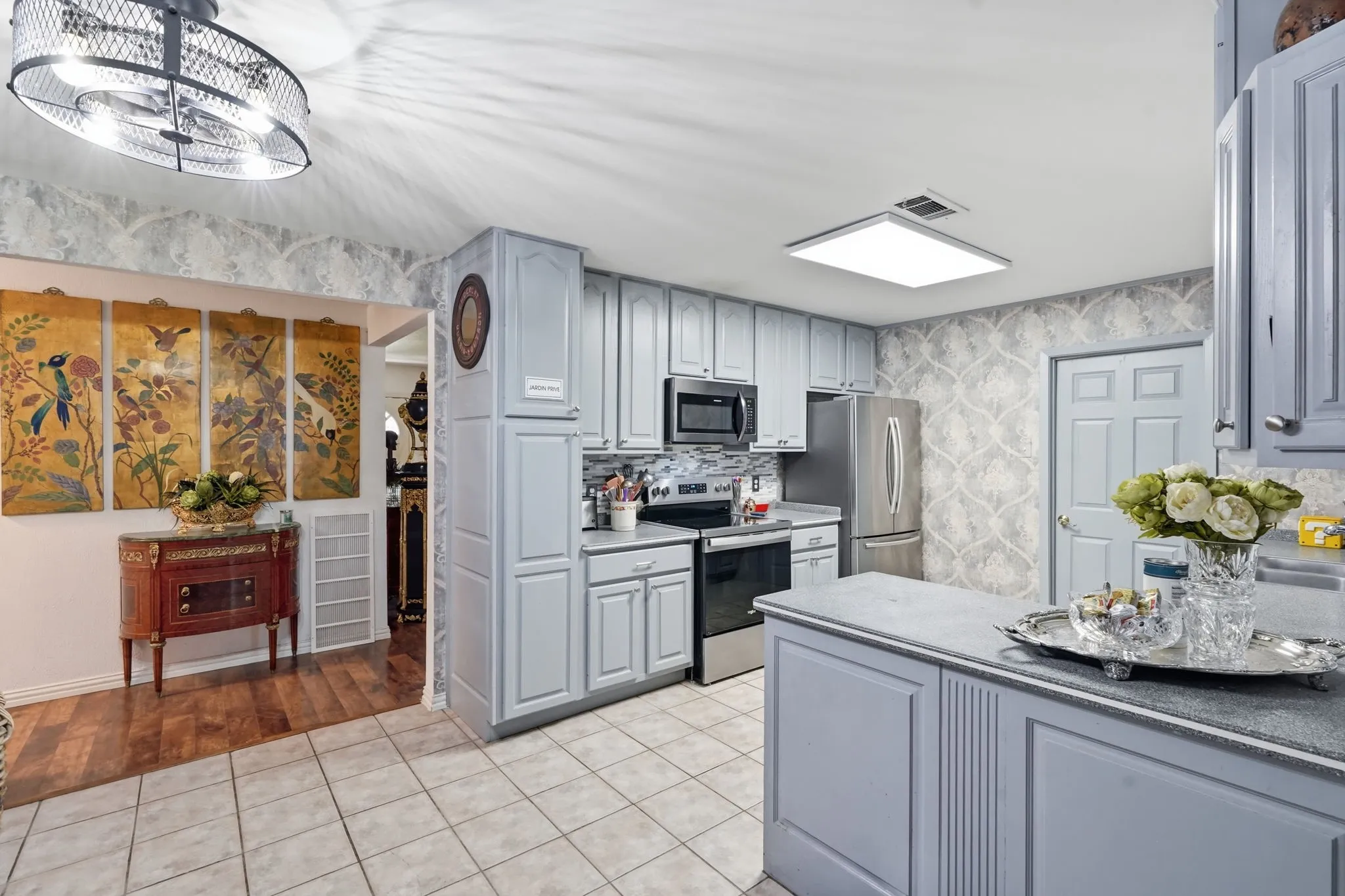 Kitchen featuring light-toned cabinetry, stainless steel appliances, a tiled backsplash, and recessed lighting