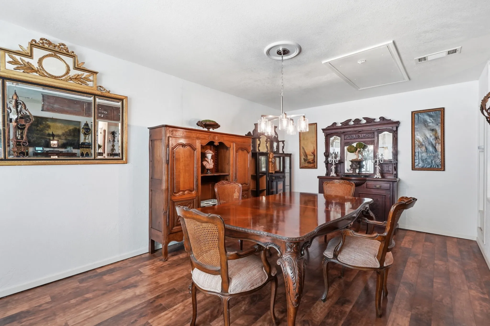 Wood-finish flooring, white walls, and a ceiling-mounted light fixture