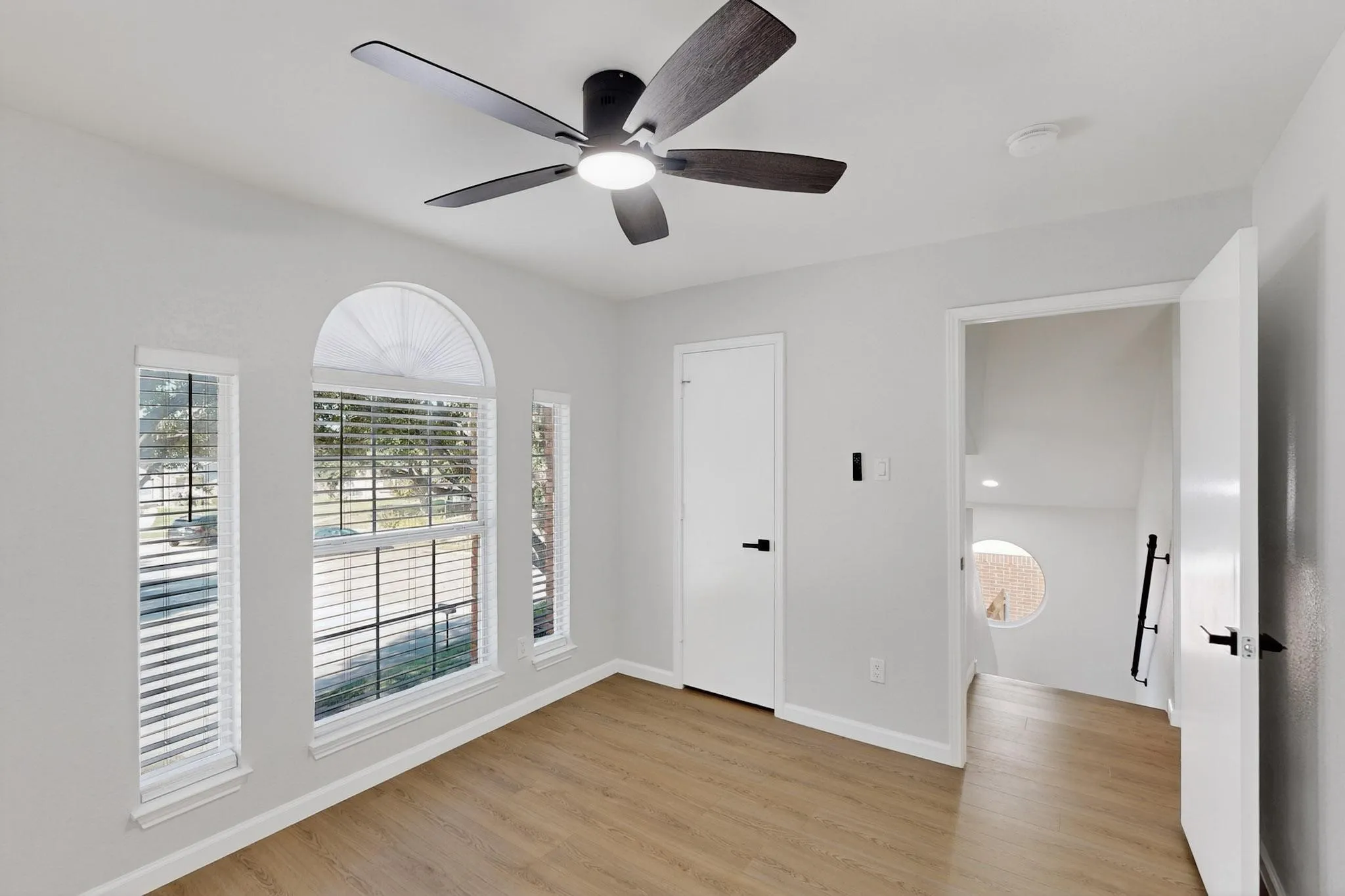 Wood-finish flooring with a contemporary ceiling fan