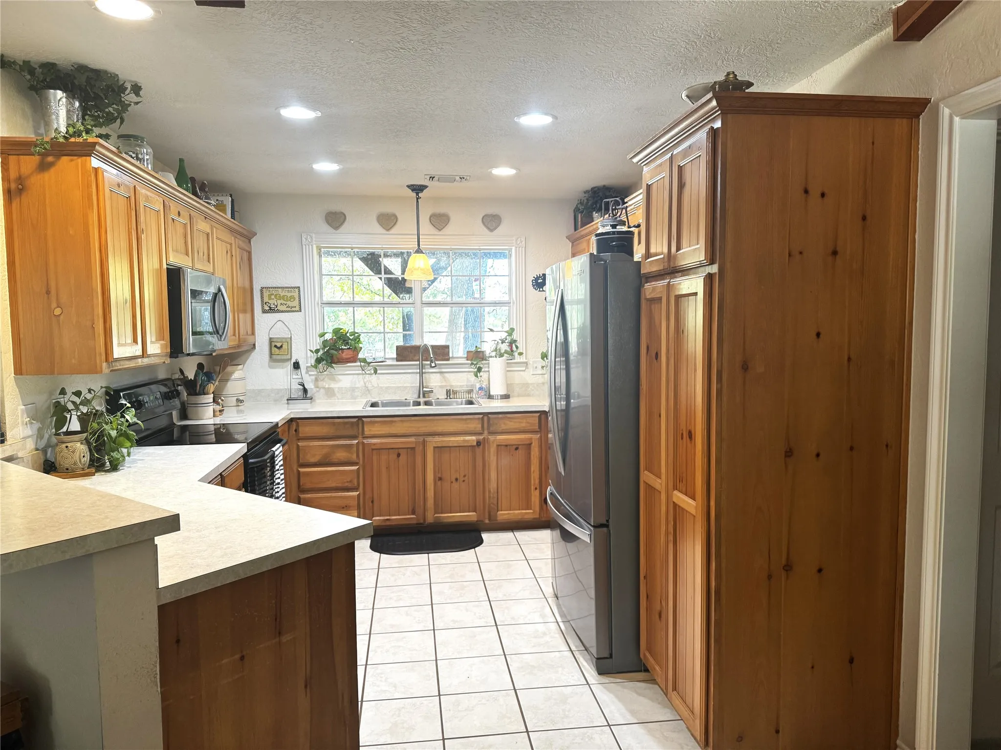 MICROWAVE ABOVE OVEN RANGE ON LEFT