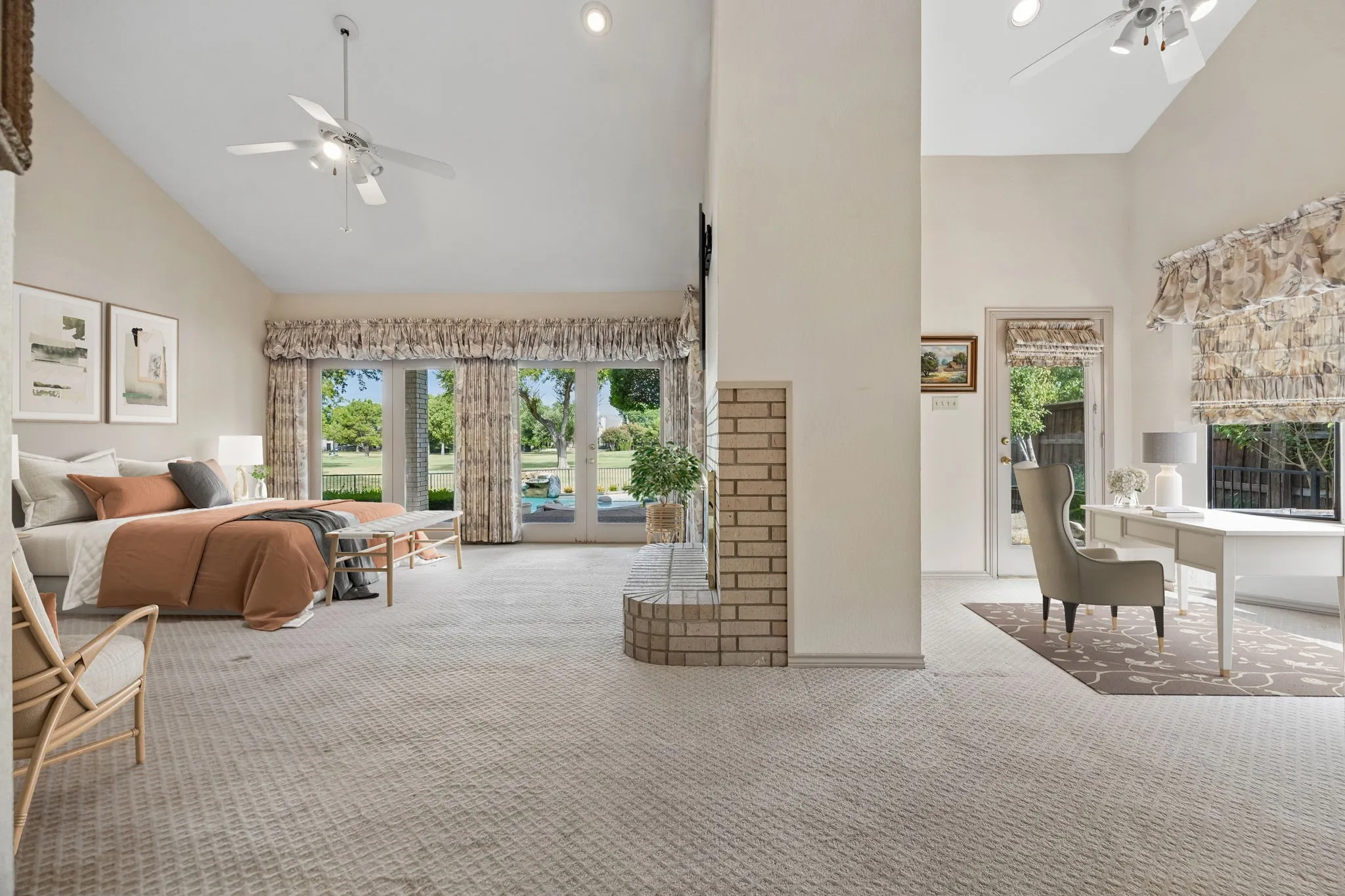 Vaulted ceilings with recessed lighting, ceiling fans, and a brick-finish fireplace