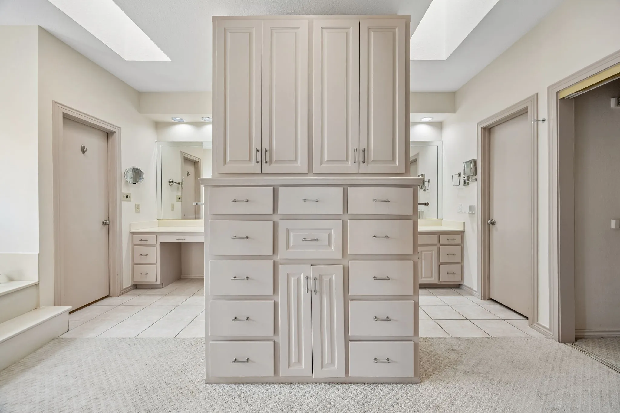 Central built-in cabinetry with multiple drawers and upper storage for Master Bath.