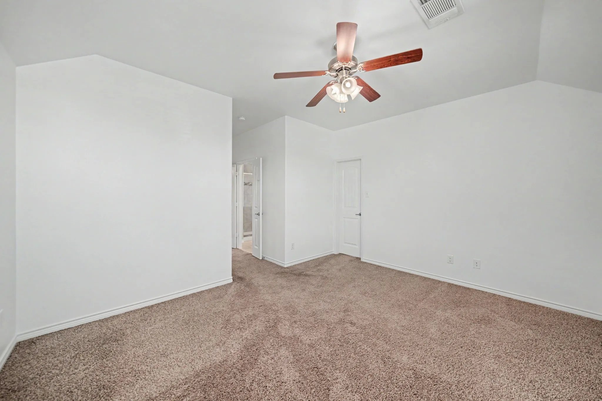 High vaulted ceiling with a ceiling fan, plush carpet flooring, and white painted walls