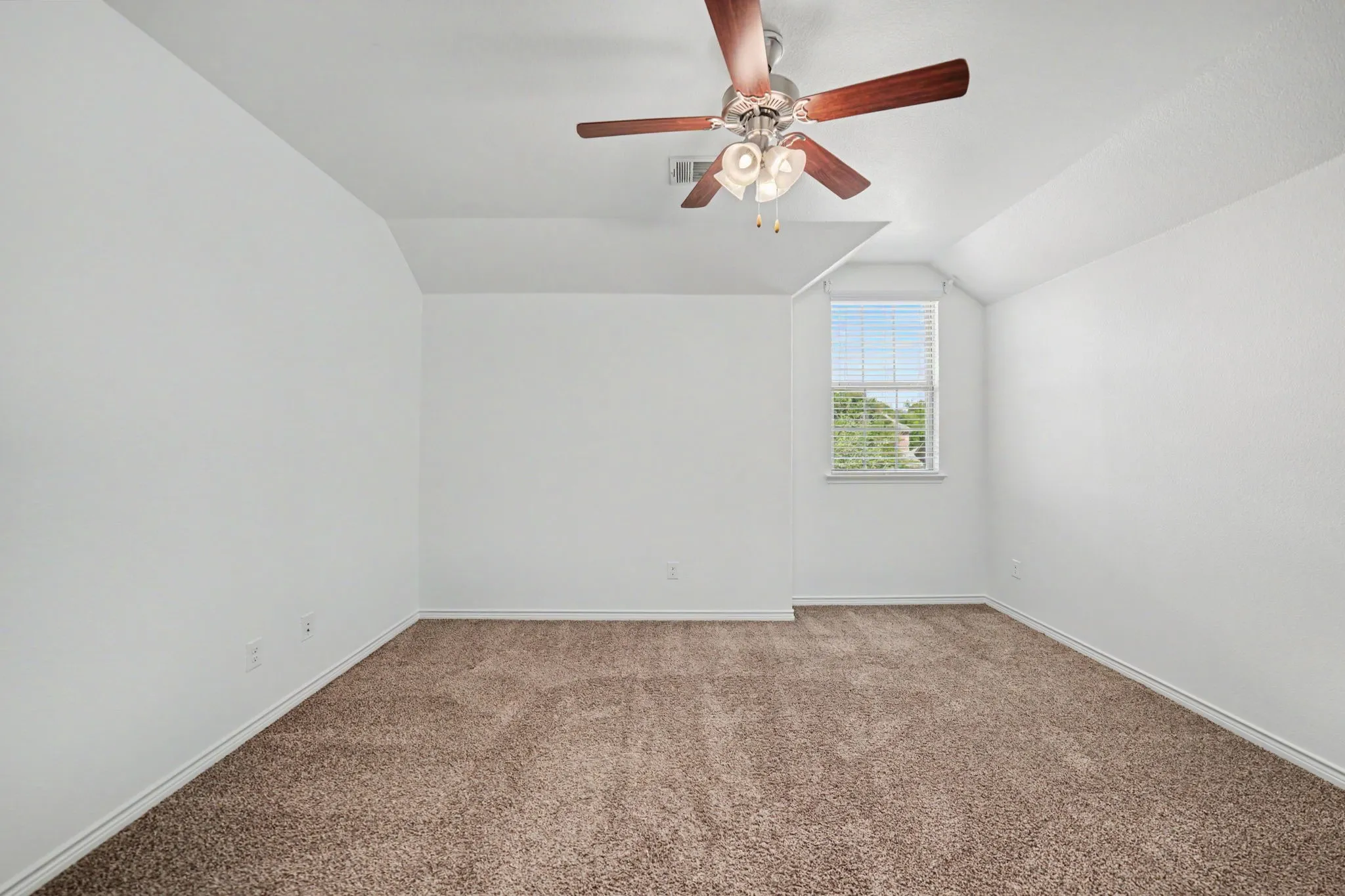 Carpeted flooring with white wall finishes, single window with blinds, and a ceiling fan with integrated lighting