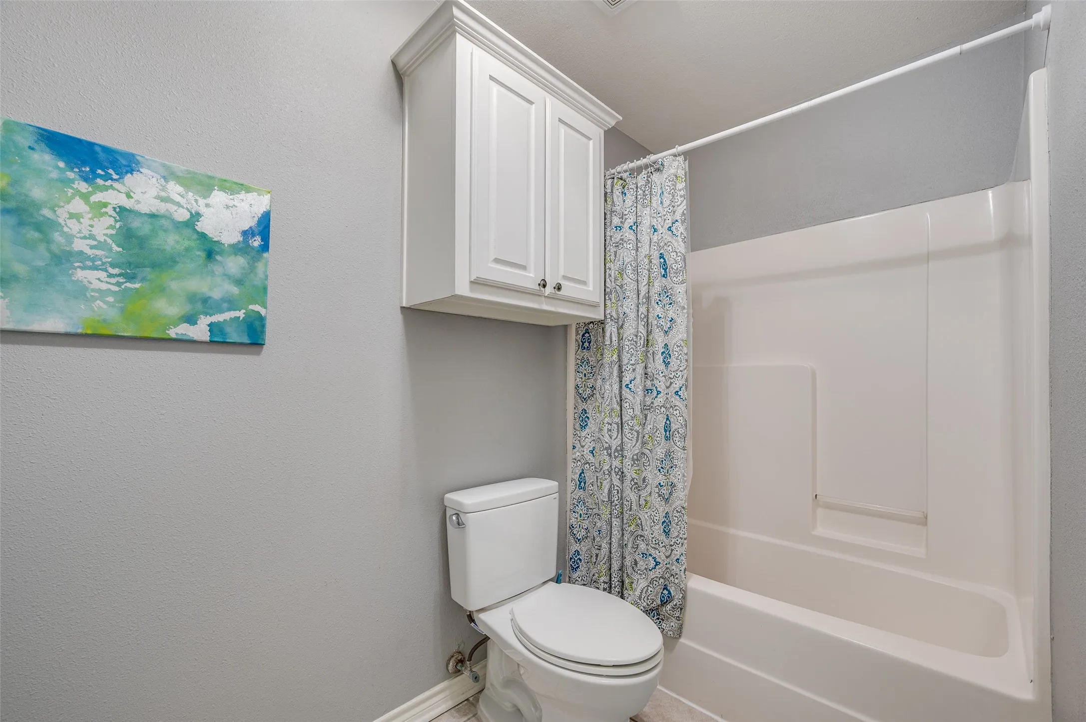 Private area within the primary bathroom with a door for additional privacy.