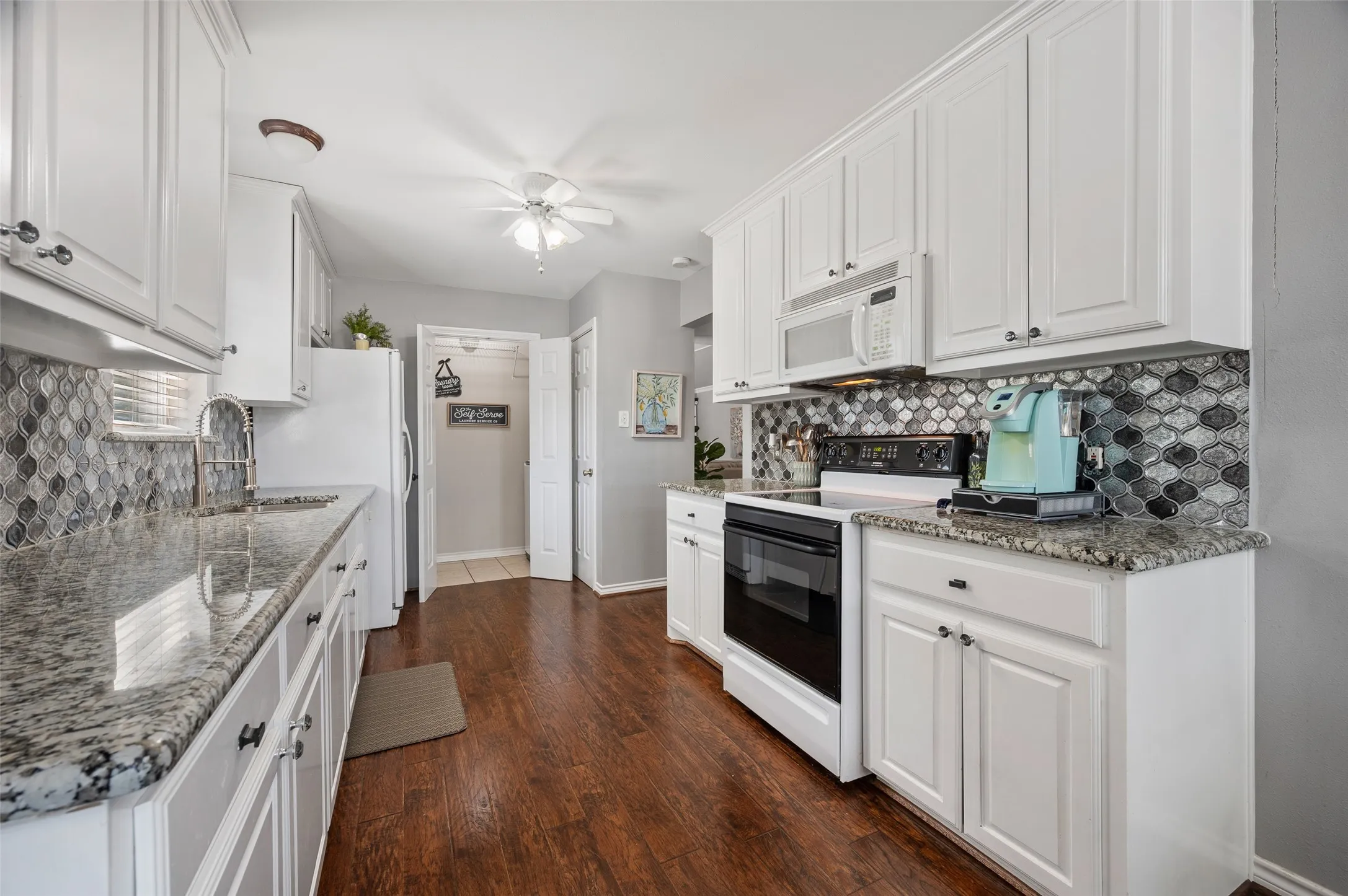 The kitchen also includes a deep pantry and access to the fully separate laundry room.